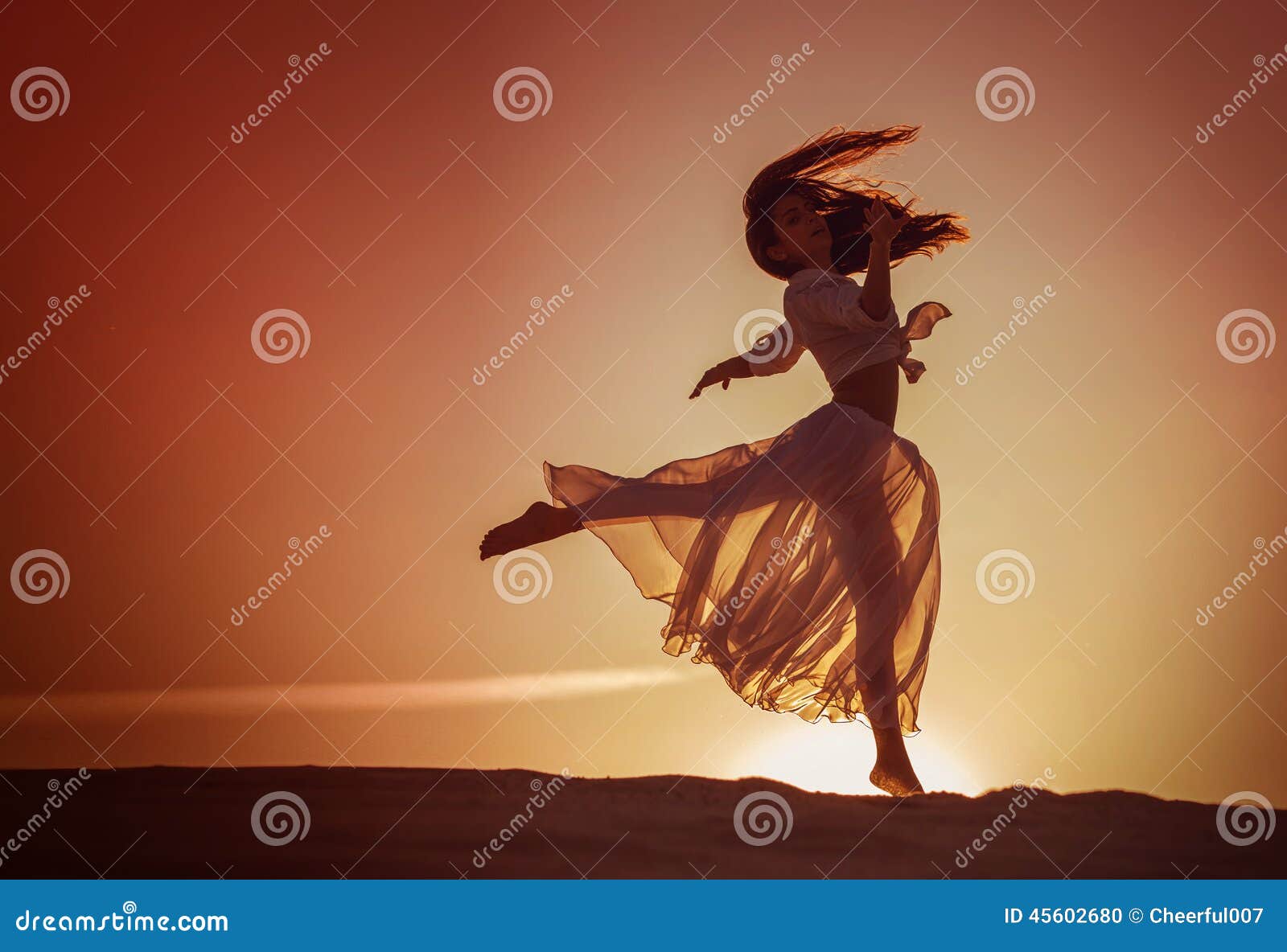 beautiful woman dancing at sunset