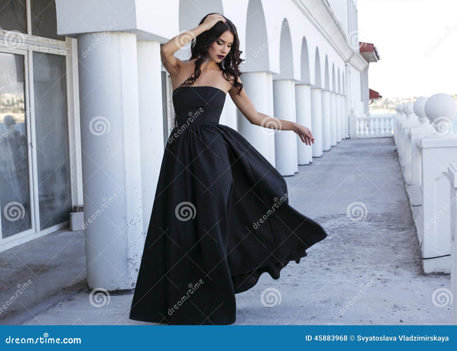 High Fashion Model in Black Dress with Golden Glitters Over Beige. Luxury  Brunette Woman in Evening Gown with Curly Hair Stock Image - Image of  fashion, elegance: 231430285