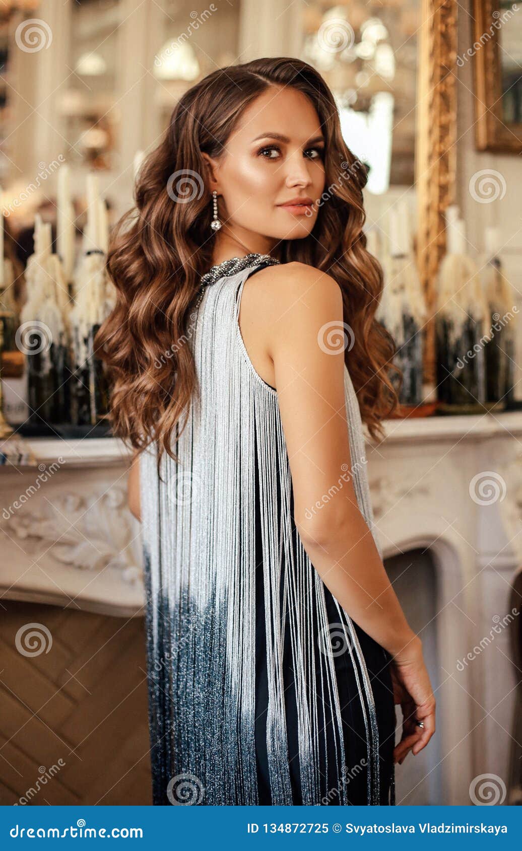 Beautiful Woman With Dark Hair In Elegant Dress Posing In