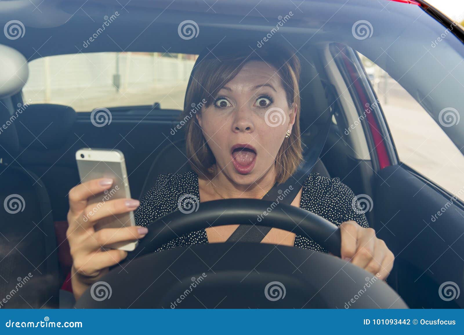 beautiful woman driving car while texting using mobile phone distracted