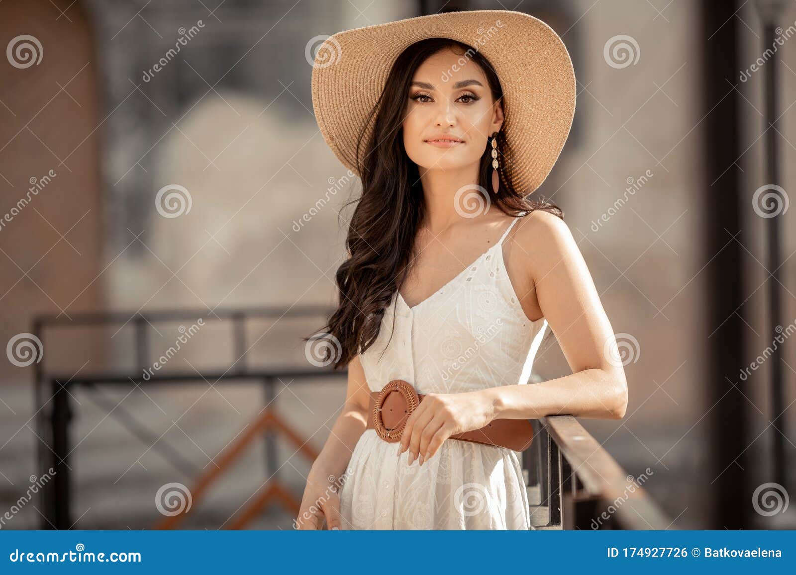 Beautiful Woman of Eastern Appearance among Ancient Street Stone