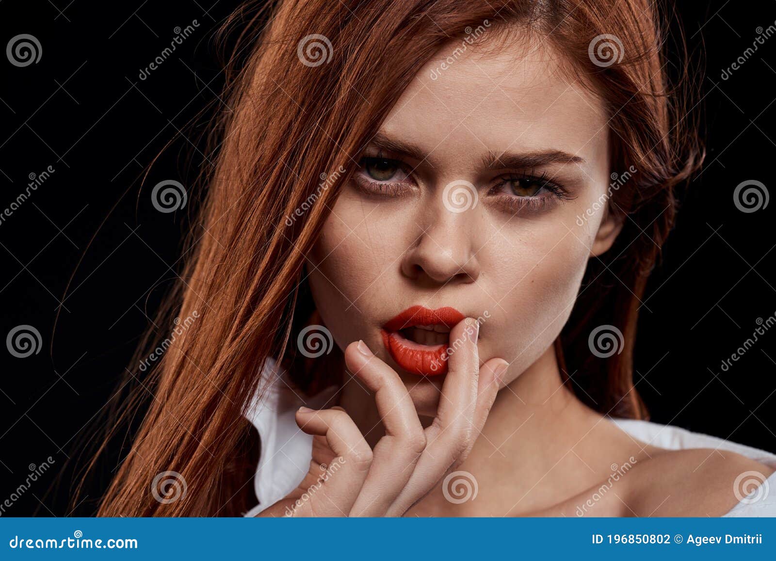 woman in an unbuttoned white shirt and red bra. Close up of female