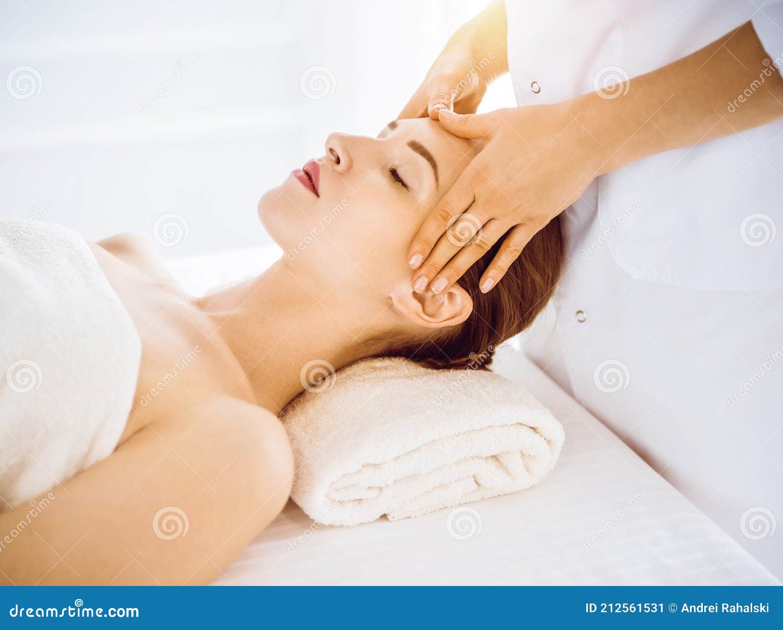 Beautiful Woman Enjoying Facial Massage With Closed Eyes In Sunny Spa Center Stock Image Image