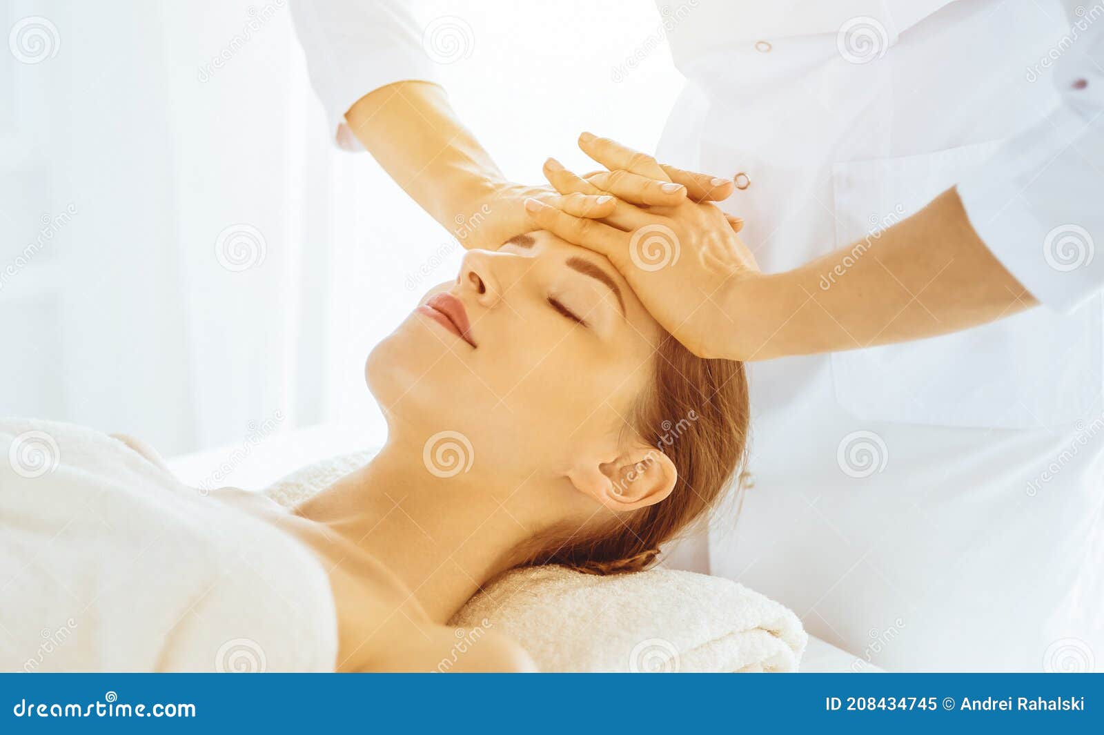 Beautiful Woman Enjoying Facial Massage With Closed Eyes In Sunny Spa Center Relaxing Treatment