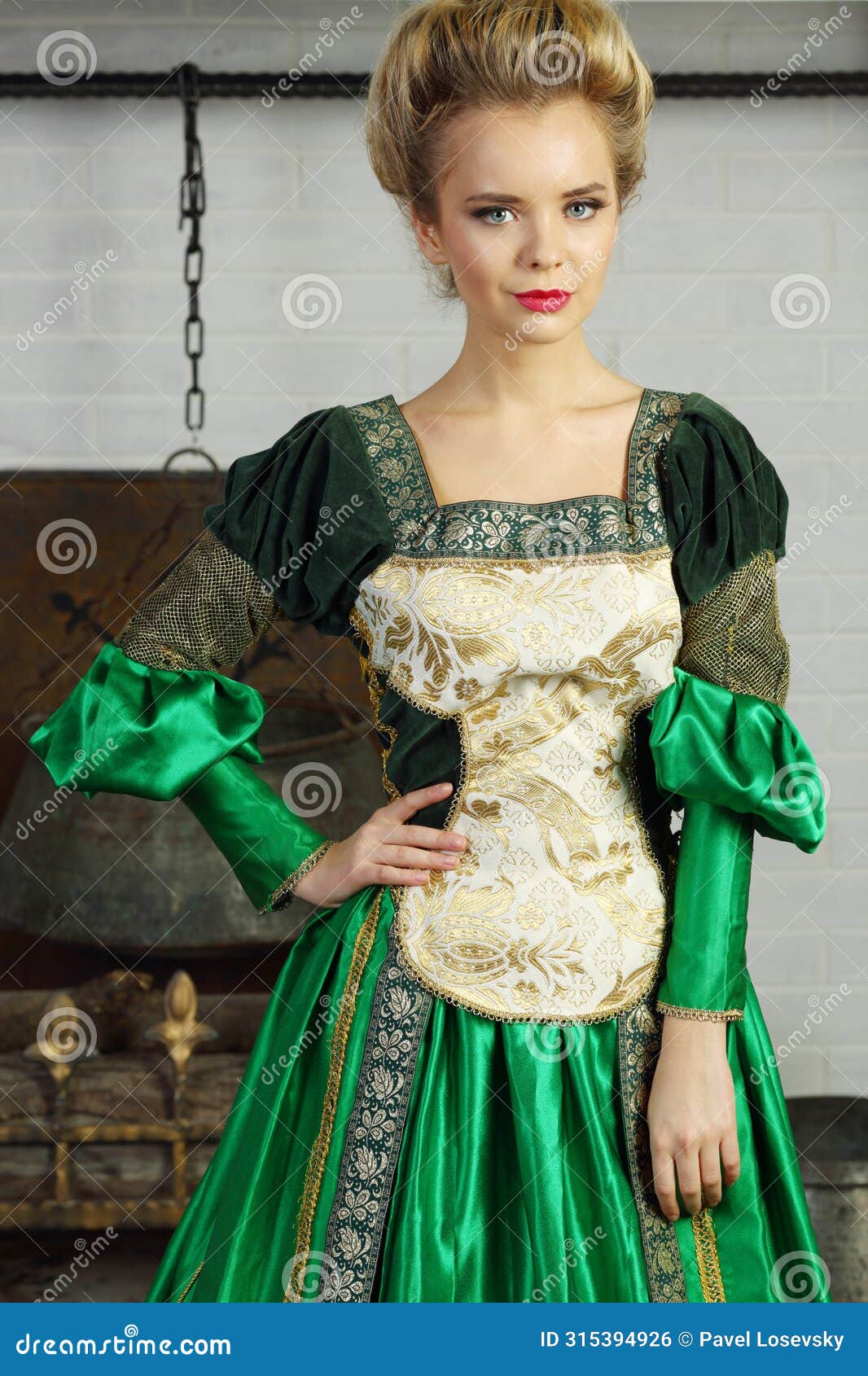 beautiful woman in green medieval costume stands