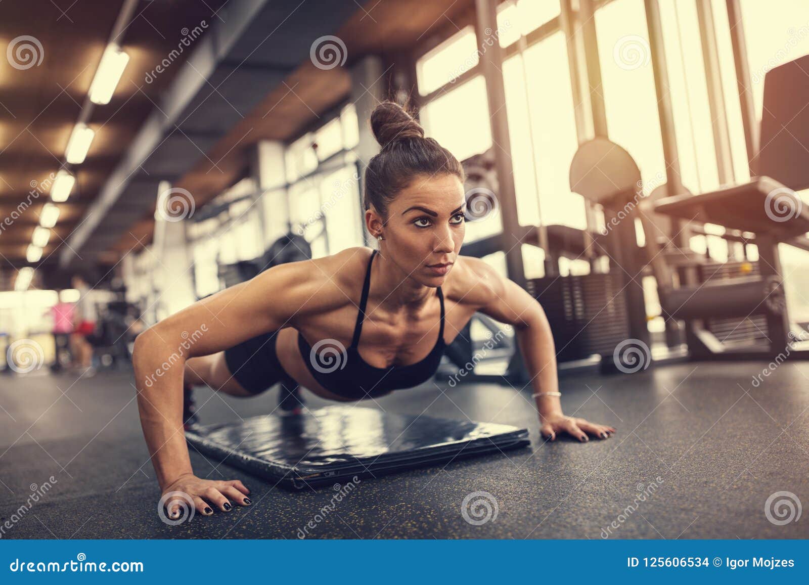Woman doing pushups in gym stock photo. Image of indoor 125606534