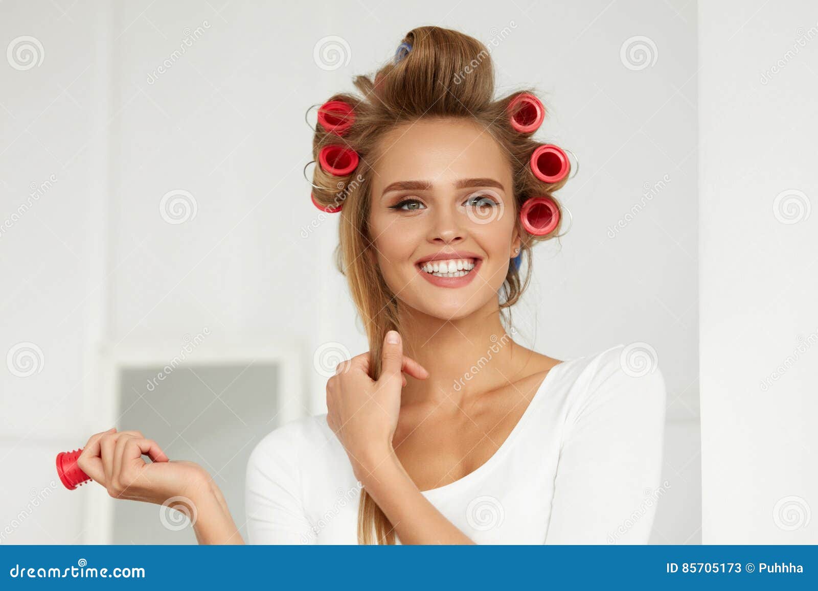 beautiful woman with hair curlers, hair rollers on healthy curly