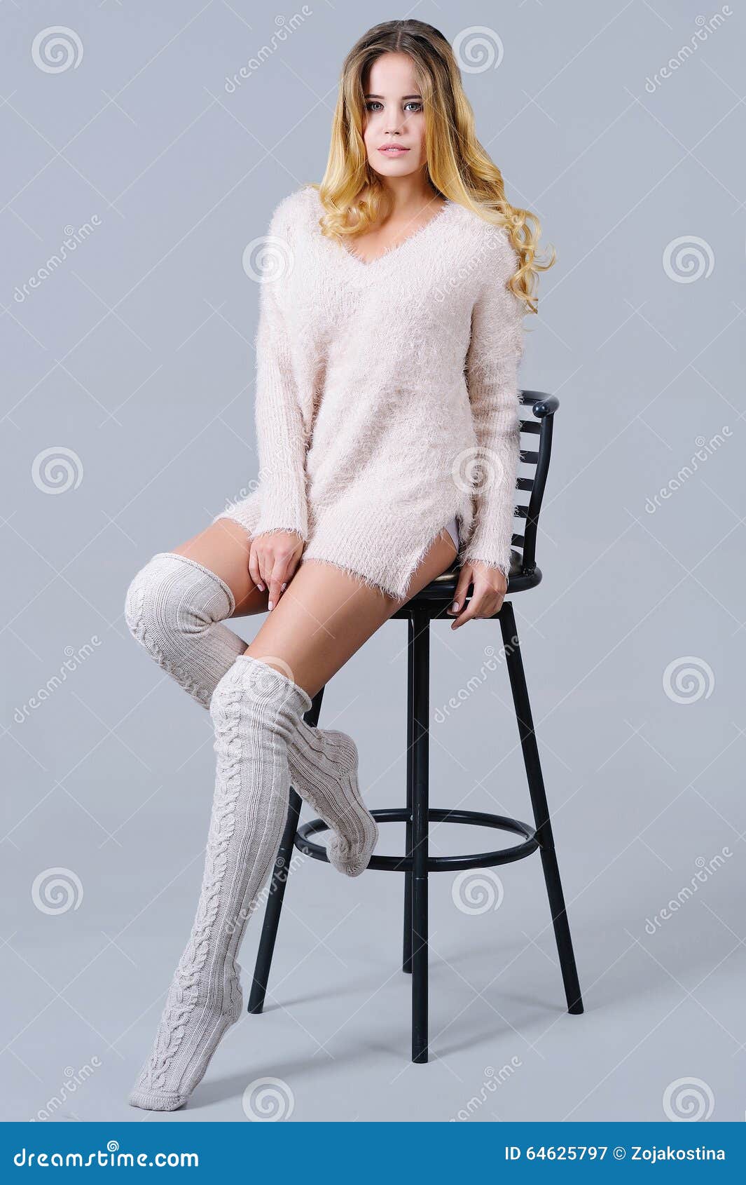 Beautiful Woman In Knitted Knee Socks Sitting On A Bar Chair Stock