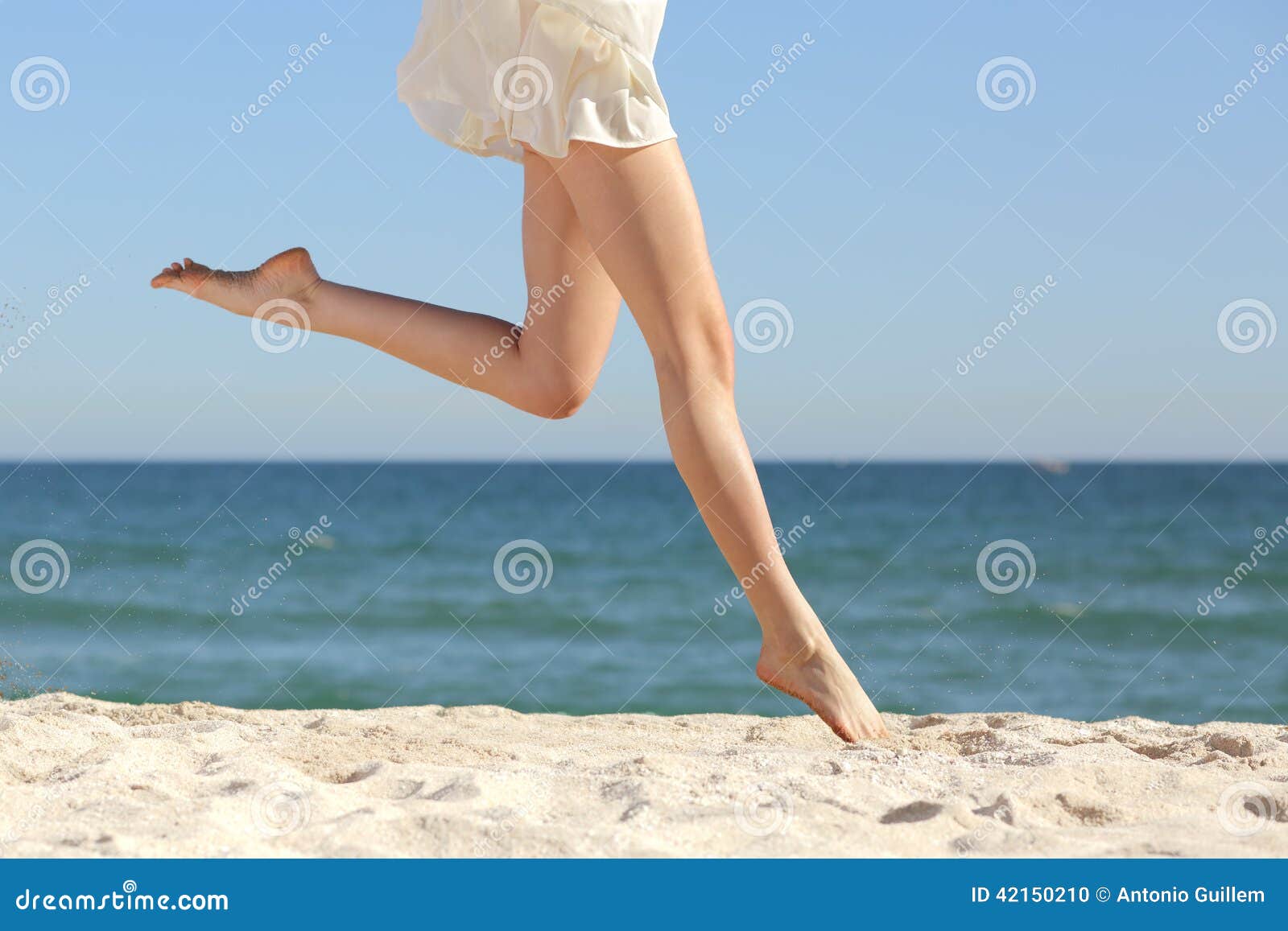 beautiful woman long legs jumping on the beach