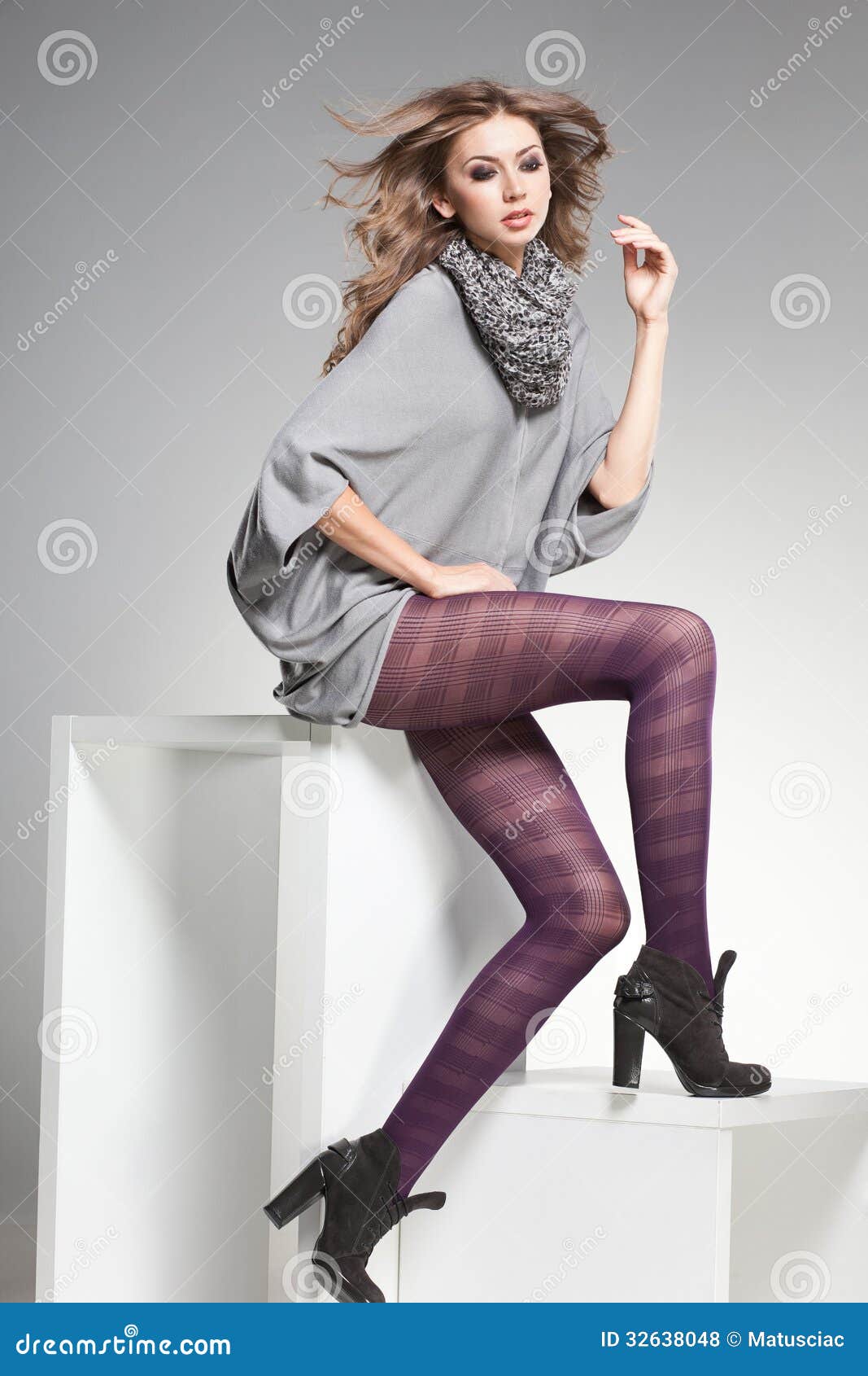 Beautiful Woman With Long Legs Dressed Elegant Posing In The Studio