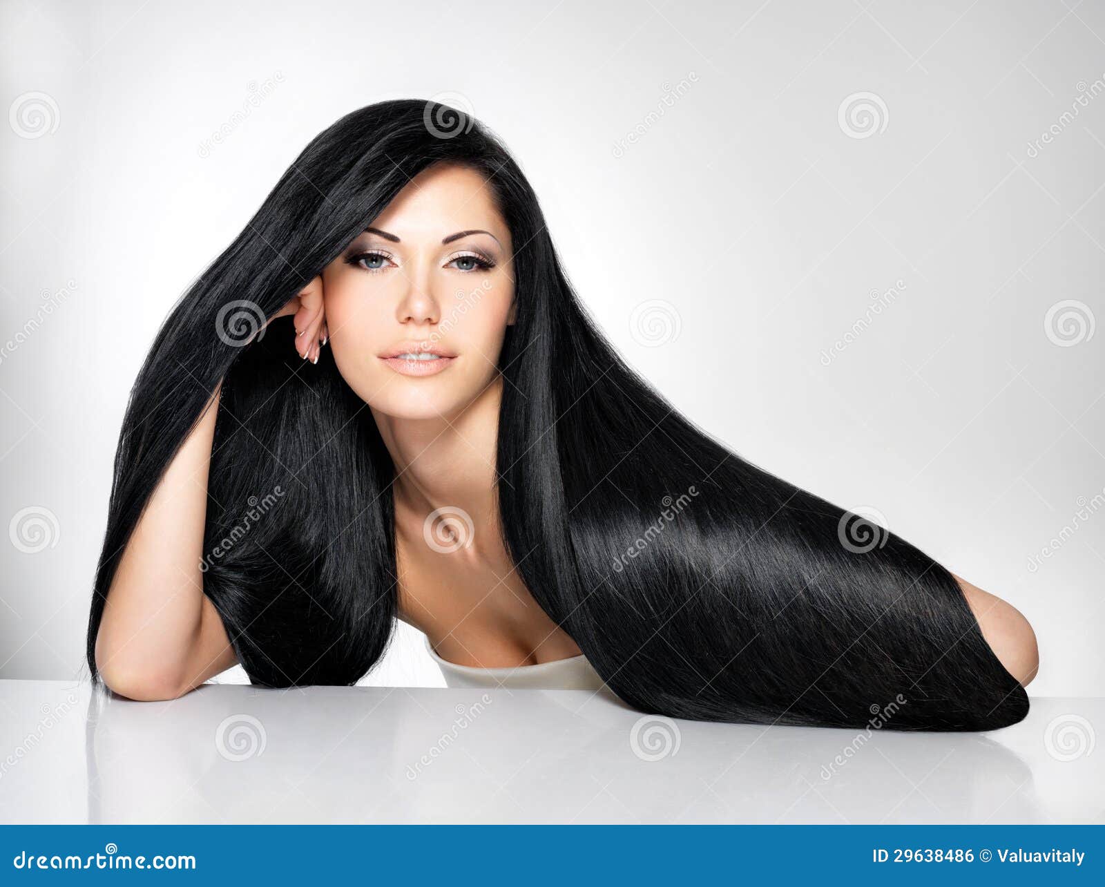 A Brunette with Long Hair Poses in the Studio Sitting on the Floor on a  Black BackgroundBlack and White Photo Stock Photo  Image of brunette  beautiful 210773988