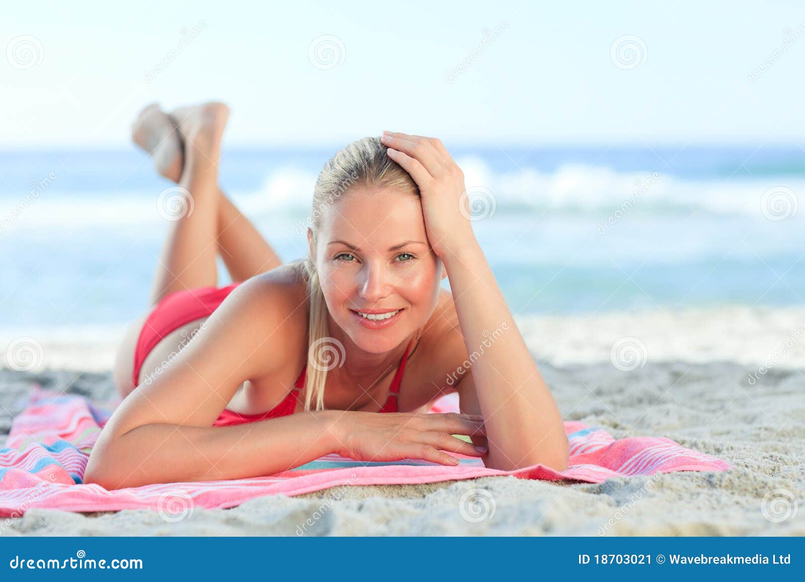 Seductive blond-haired woman with perfect breast and body in fashion bikini  inside the crystal clear sea posing for the camera. Summer beach vacation.  Phuket. Thailand Stock Photo