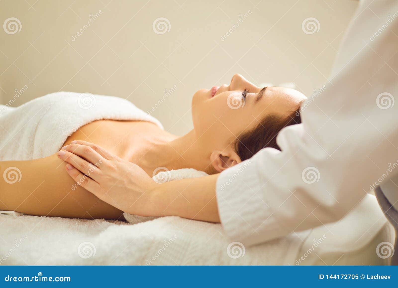 Beautiful Woman Is Lying On The Massage Desk In The Spa Salon Stock