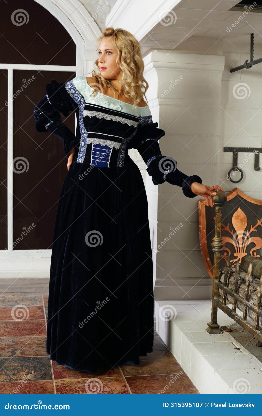 beautiful woman in medieval costume stands near