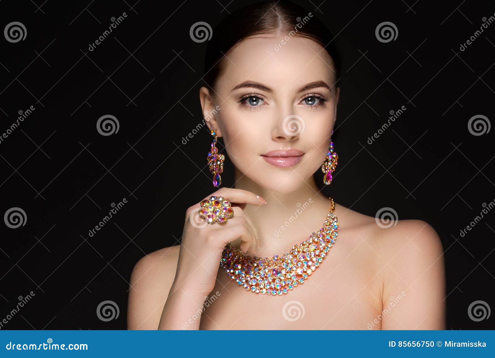 beautiful woman in a necklace, earrings and ring. model in jewel