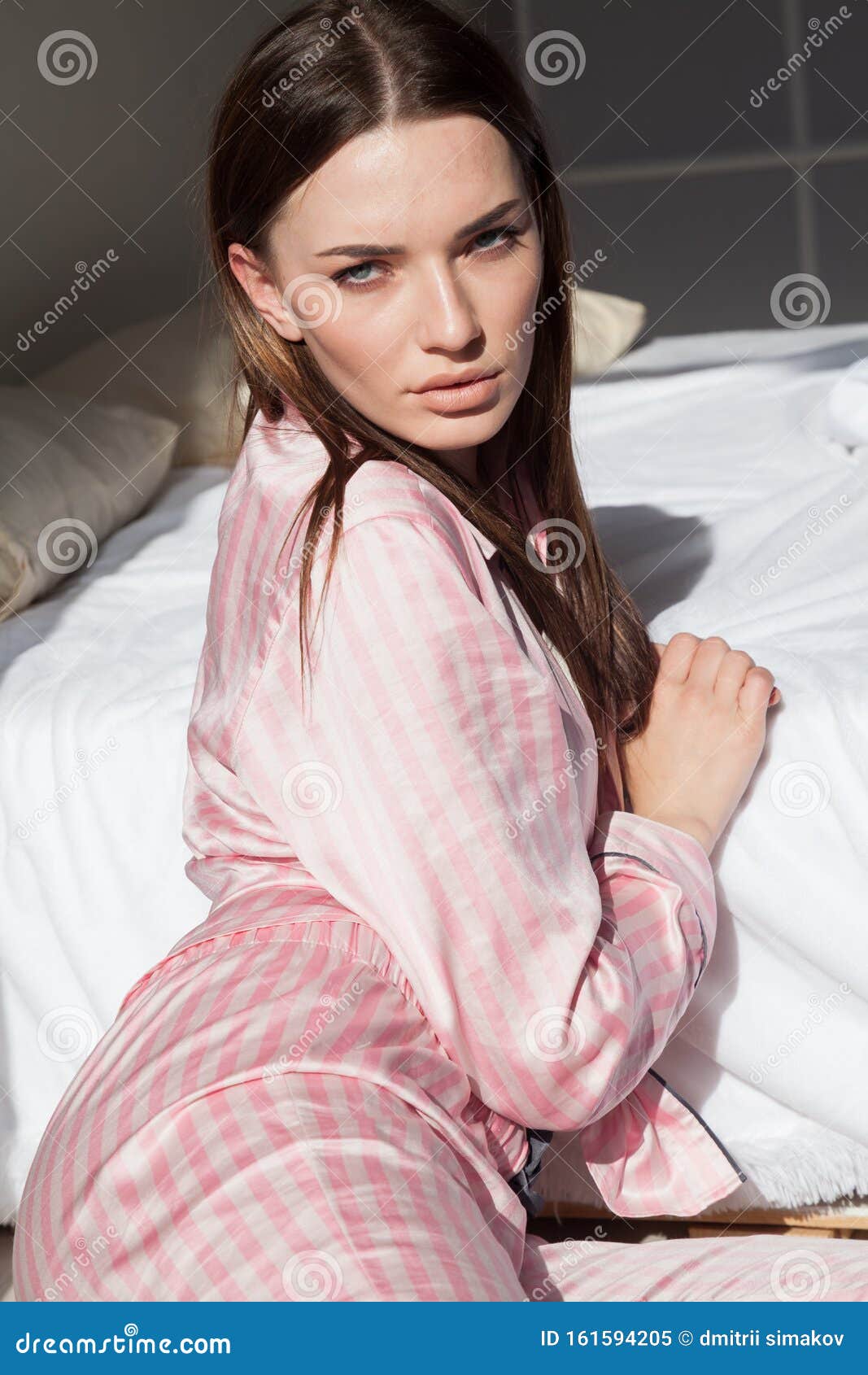 Beautiful Woman in Pajamas in the Bedroom on the Bed Stock Image ...