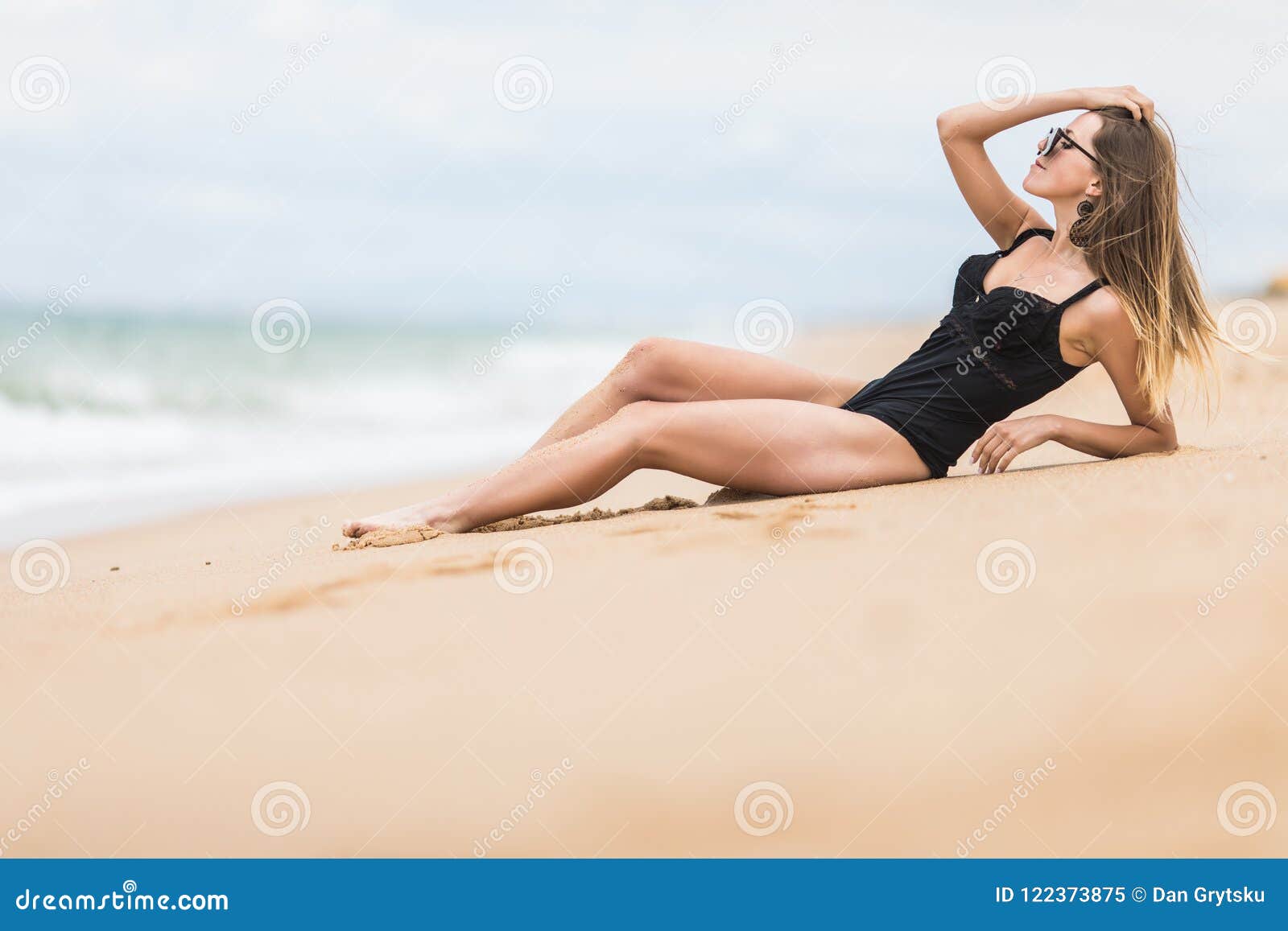 Beautiful Young Woman With Perfect Body Lying Down On The Beach Tanning On A Beach Resort