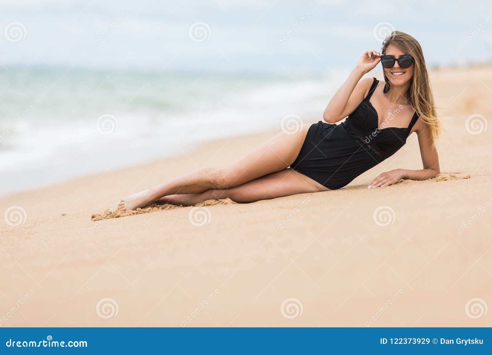 Beautiful Young Woman With Perfect Body Lying Down On The Beach