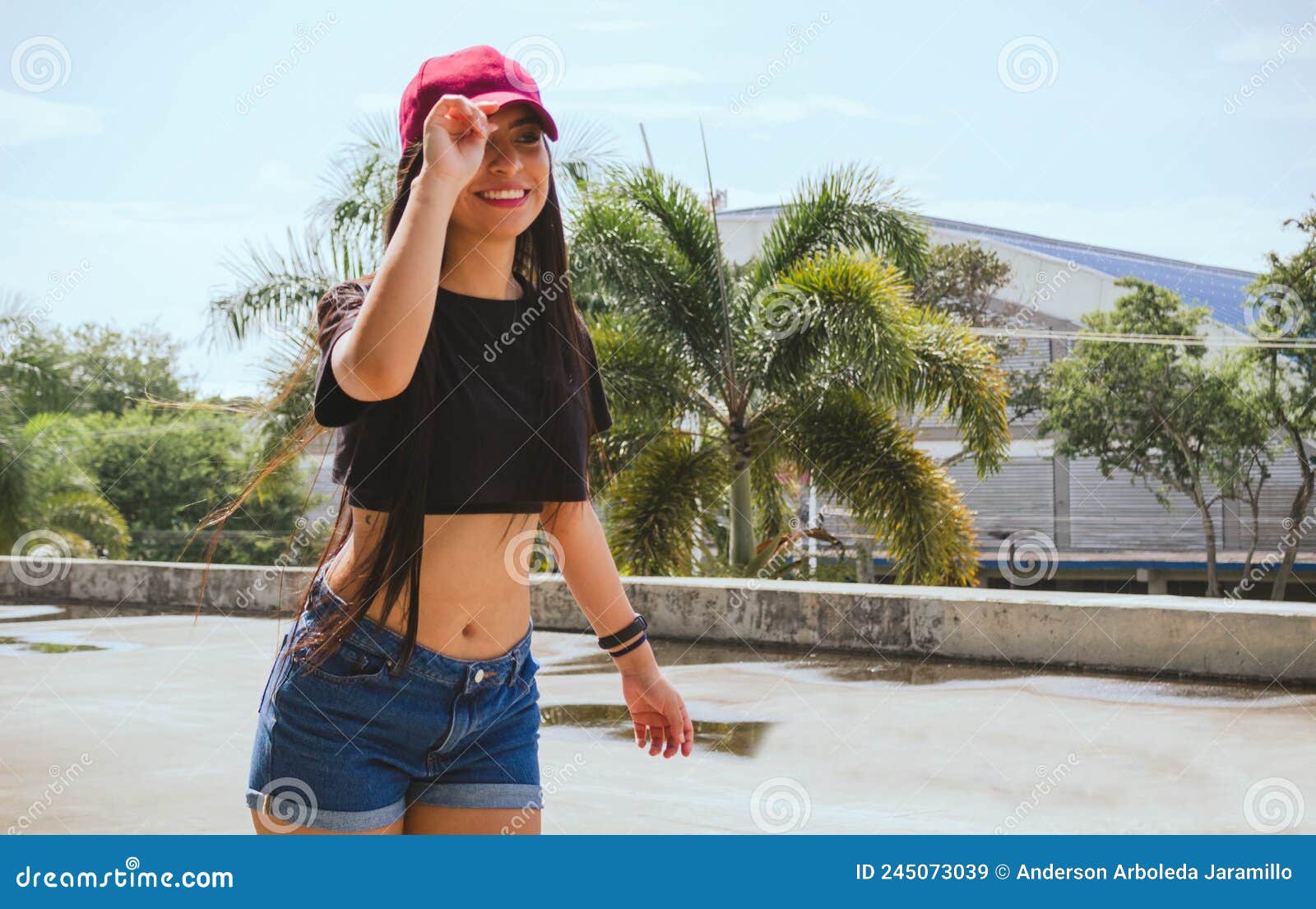 beautiful woman in pink cap skating in the park outdoors having fun