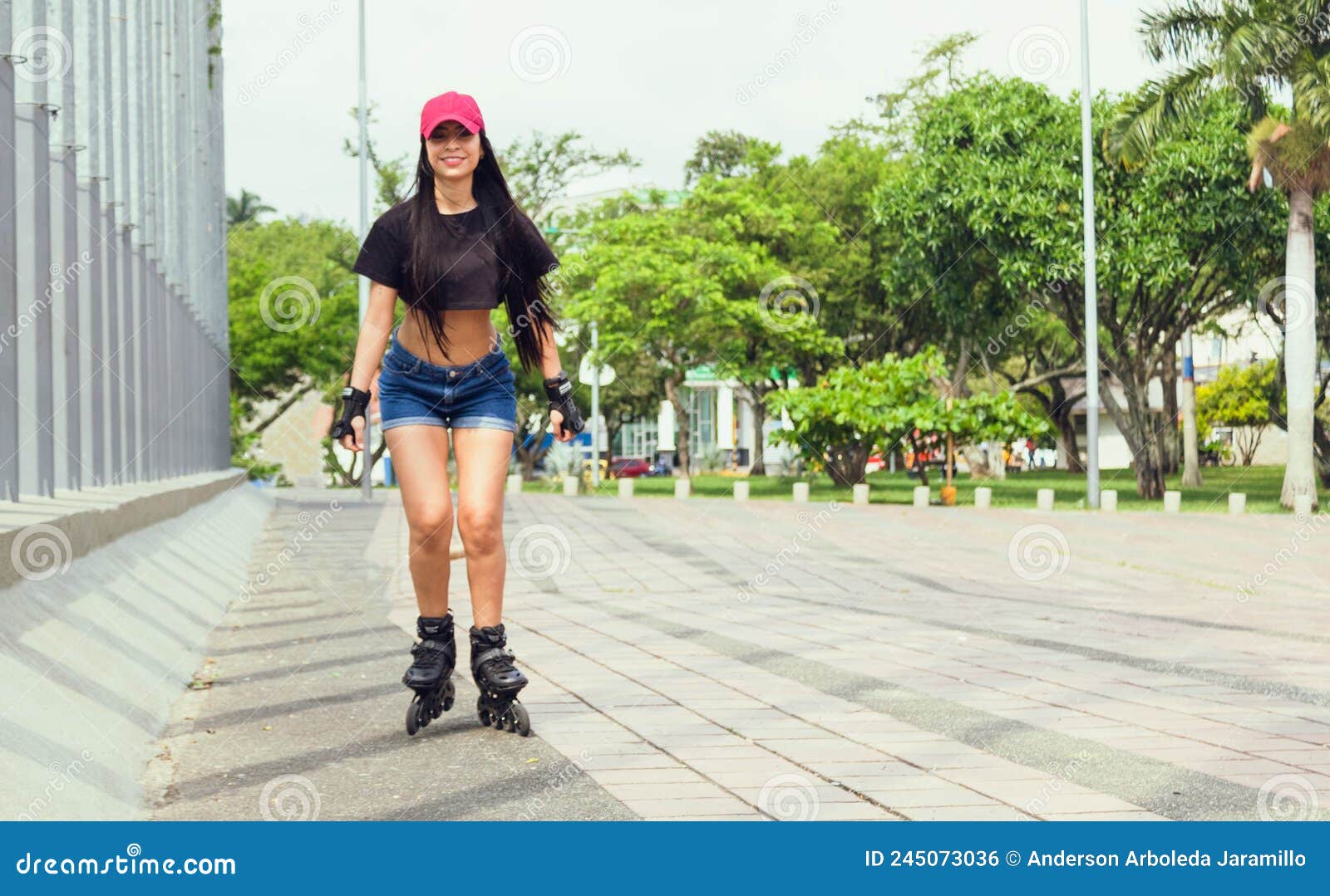 beautiful woman in pink cap skating in the park outdoors having fun