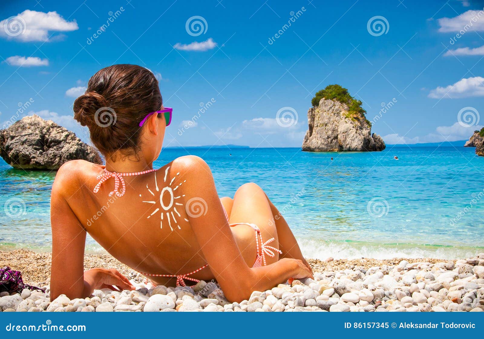 woman on piso kryoneri beach in parga, greece.