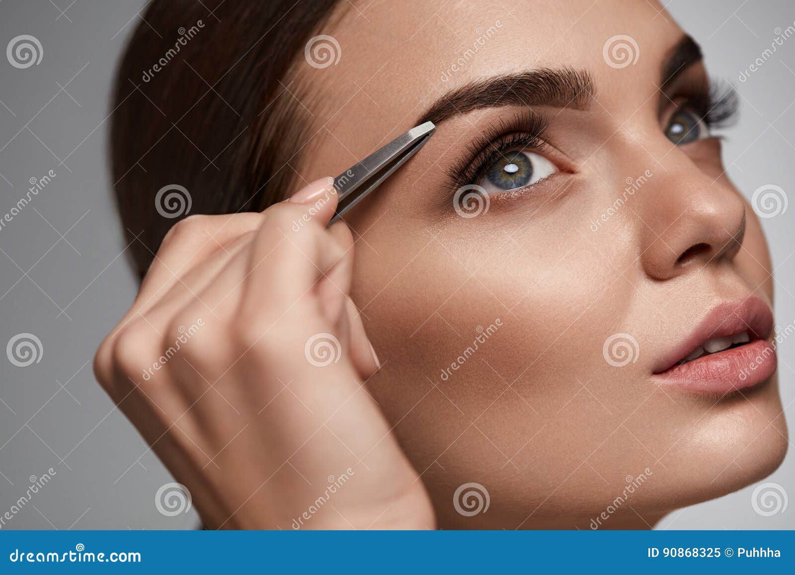 beautiful woman plucking eyebrows. beauty brows correction
