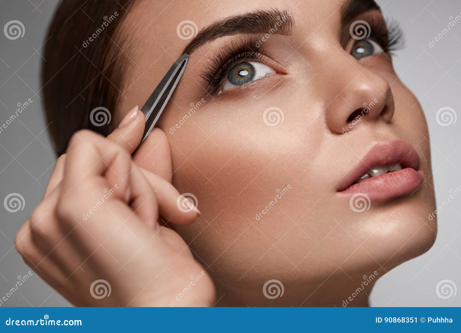 beautiful woman plucking eyebrows. beauty brows correction
