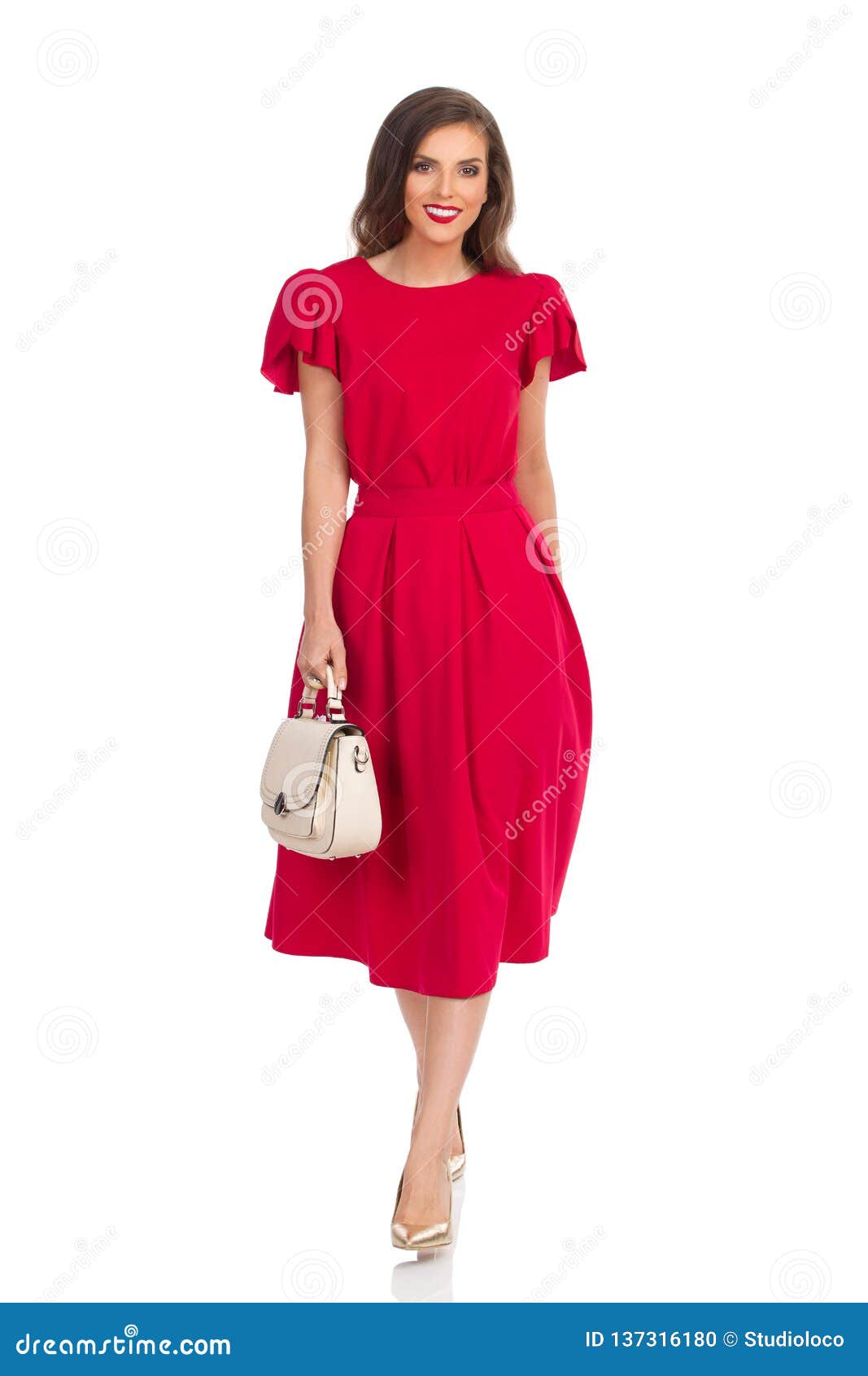 Beautiful Woman in Red Dress, Gold High Heels and Beige Purse is ...