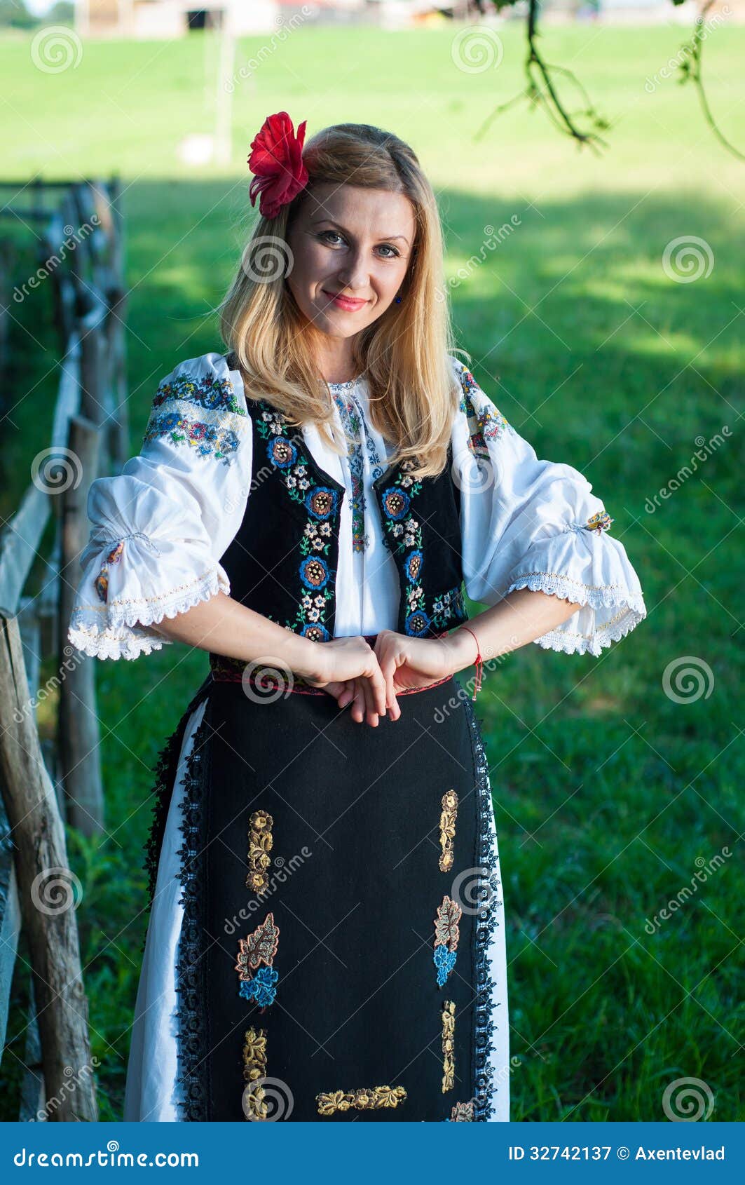 Beautiful Woman with Red Flower in Her Hair Posing in Romanian T Stock ...