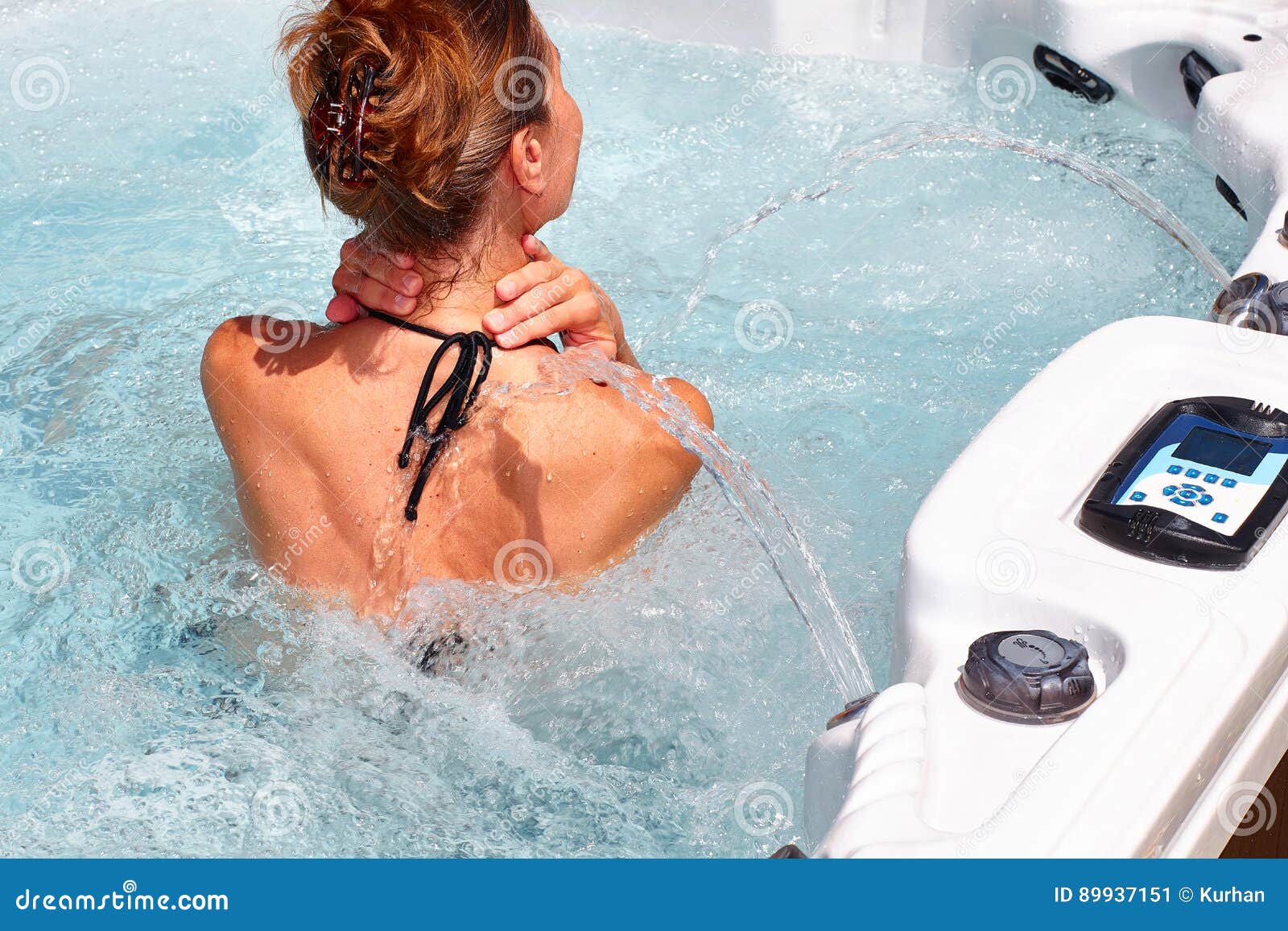 beautiful woman relaxing in hot tub.