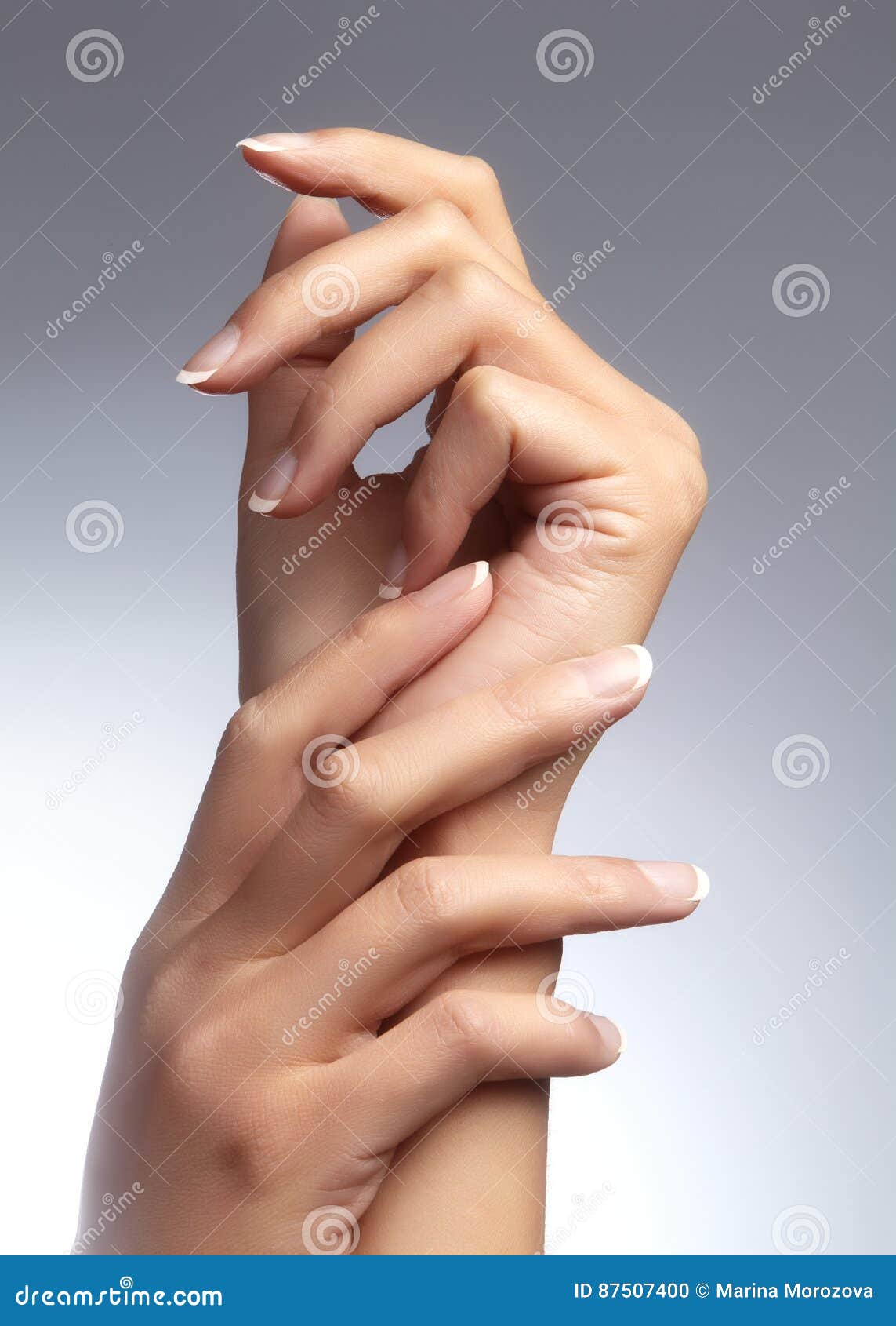 beautiful woman`s hands on light background. care about hand. tender palm. natural manicure, clean skin. french nails