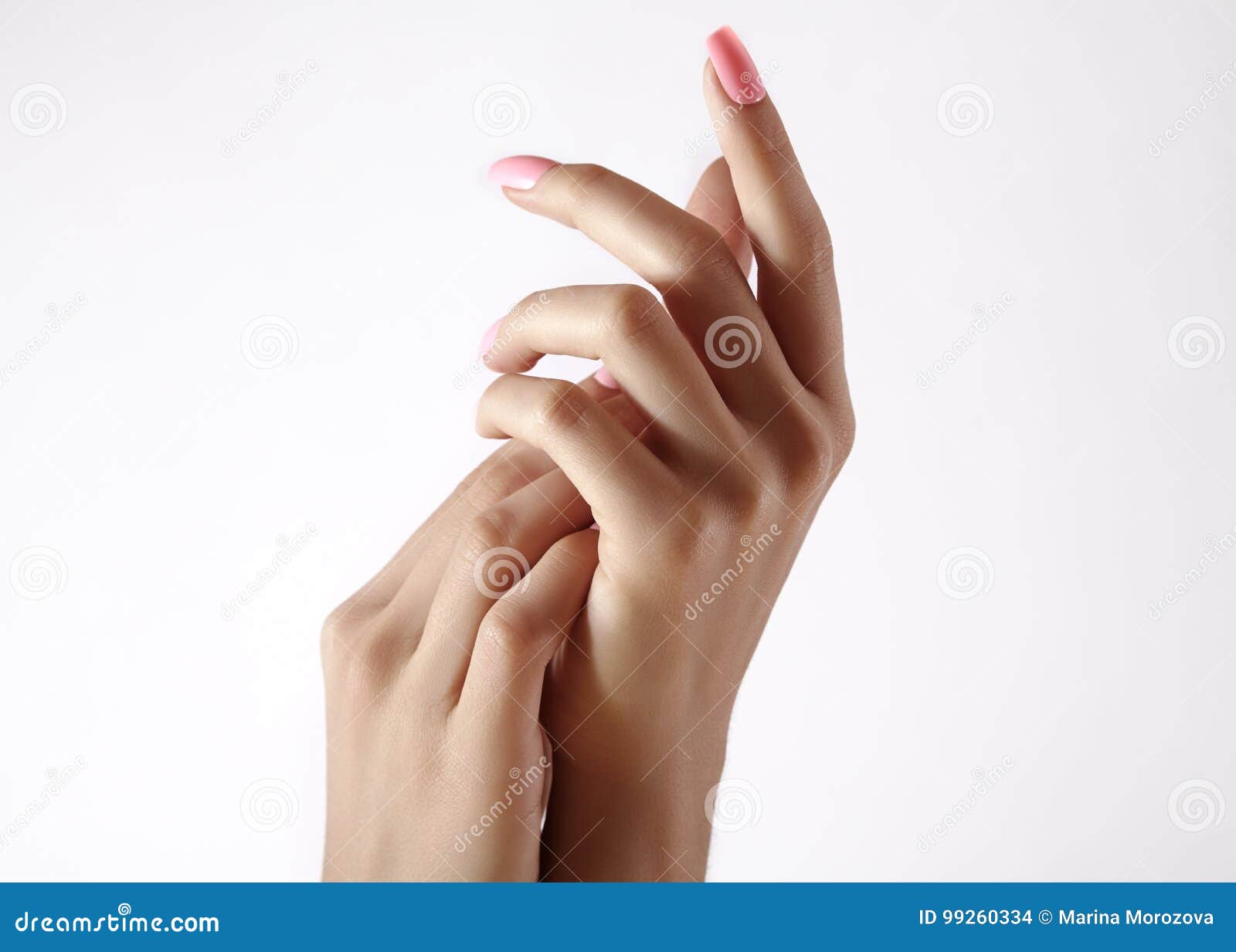 beautiful woman`s hands on light background. care about hand. tender palm. natural manicure, clean skin. pink nails