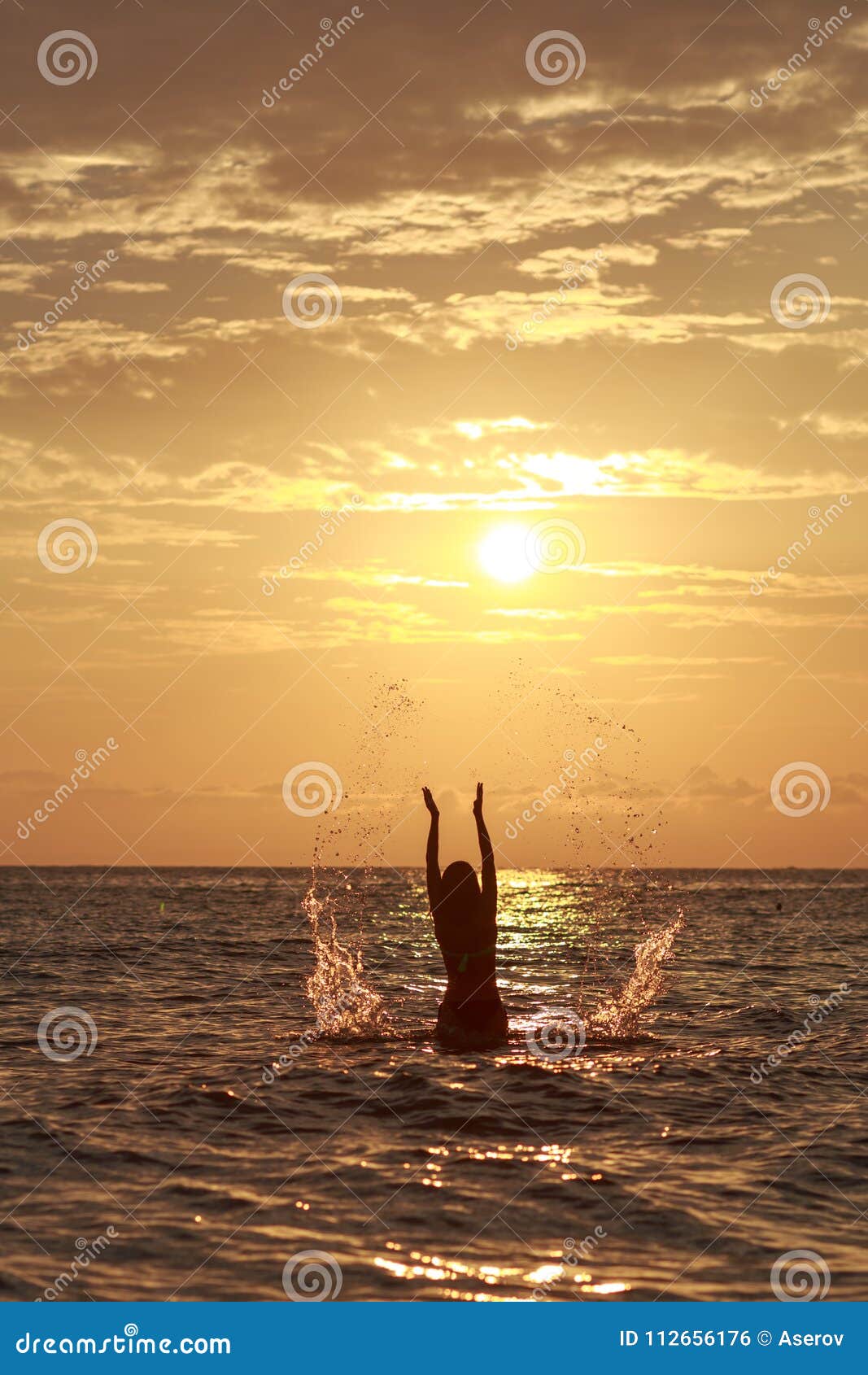 Beautiful Woman in the Sea Waves and Enjoying Sunshine with Open Arms ...