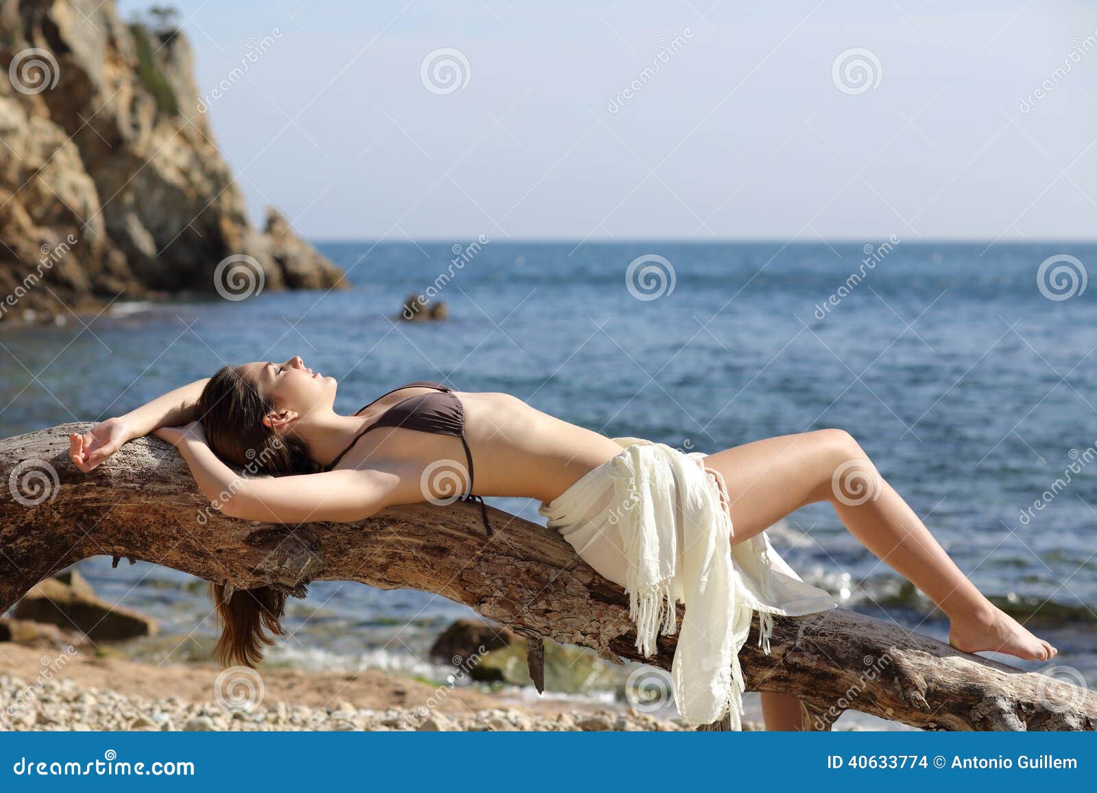 beautiful woman sunbathing on the beach on vacations