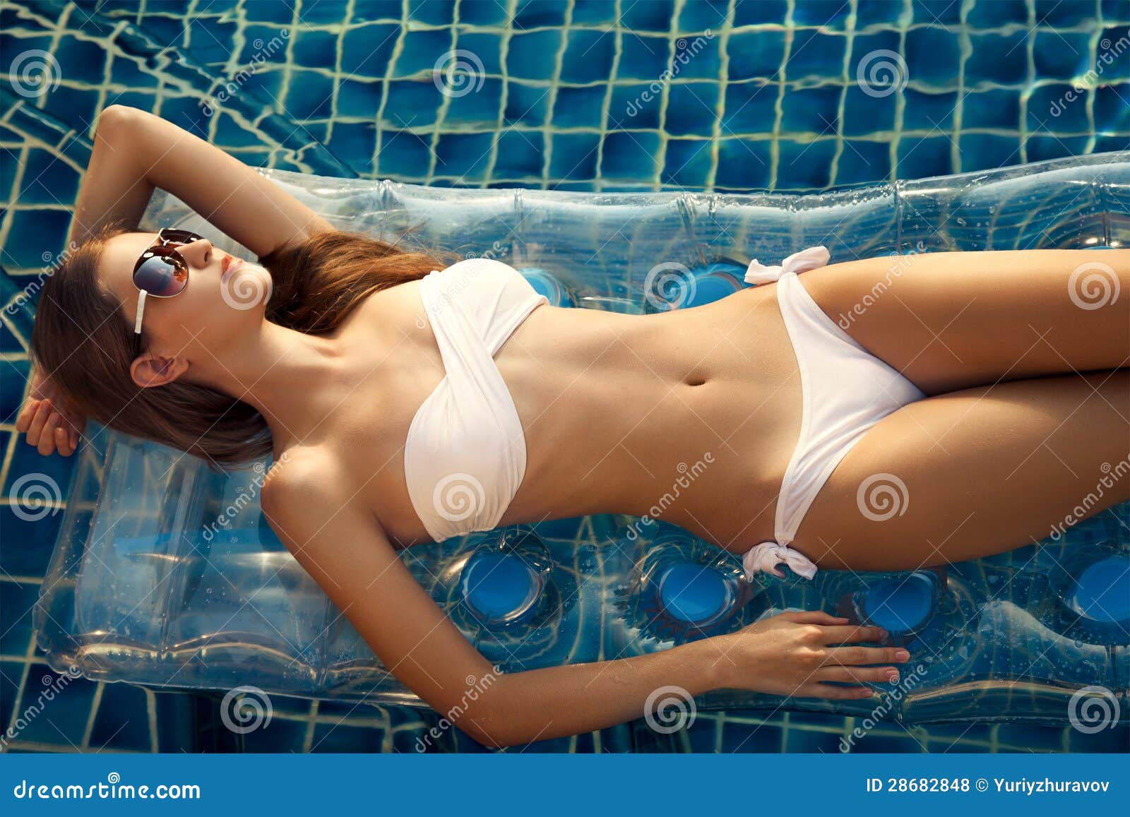 beautiful woman sunbathing in swimming pool
