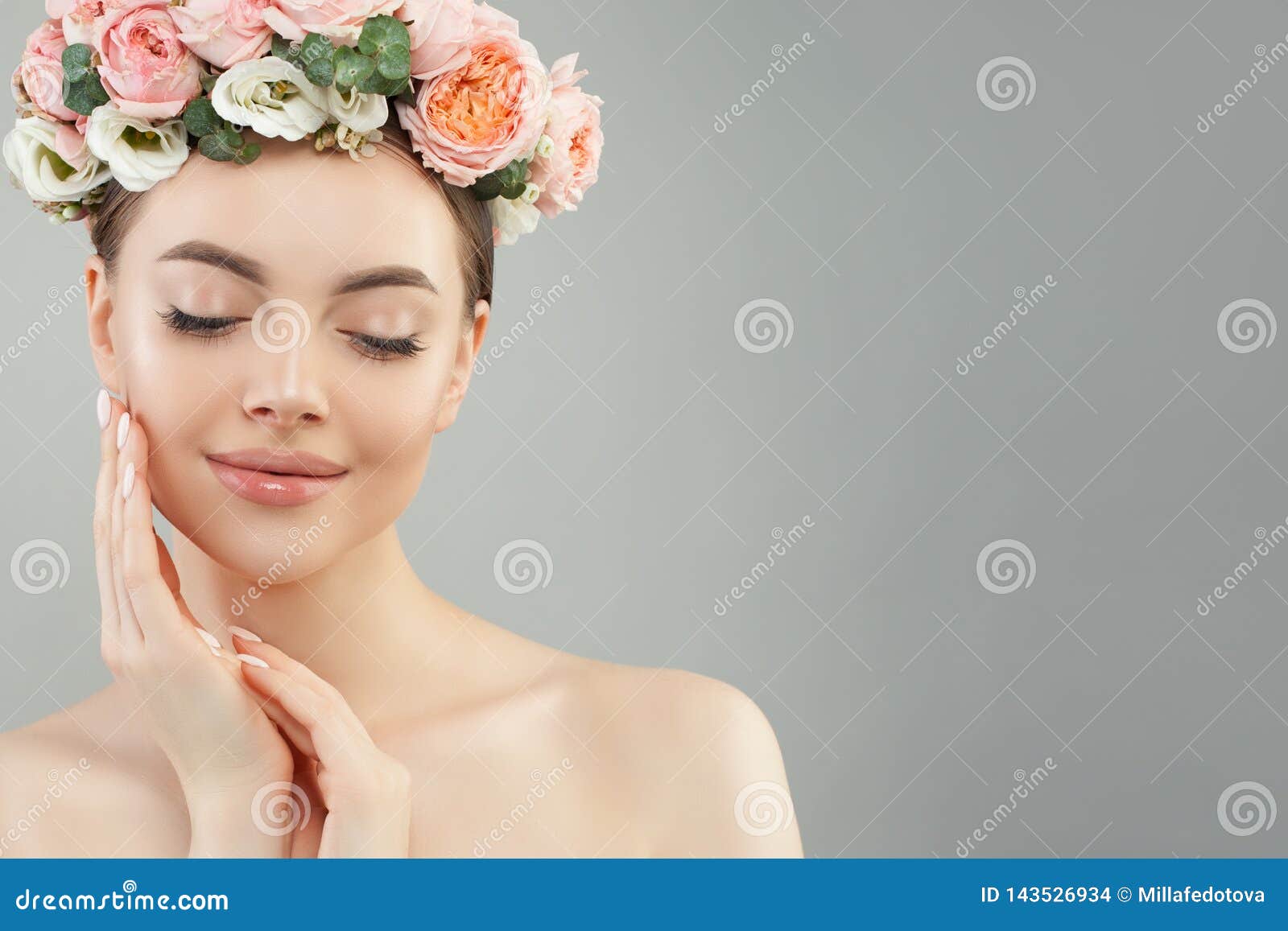 beautiful woman touching her face her hand. pretty candid girl with flowers. facial treatment, face lifting, anti aging