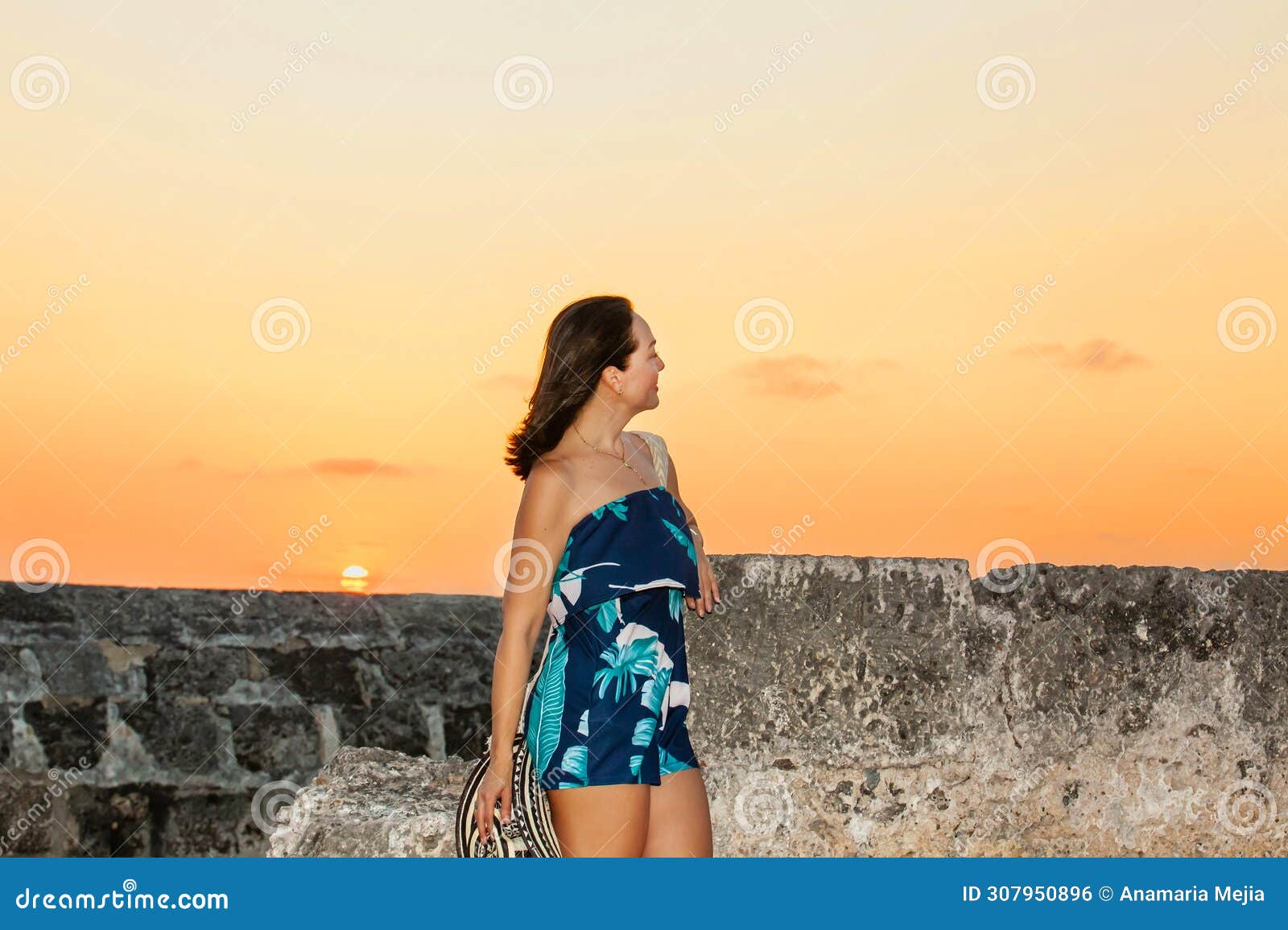 beautiful woman with the traditional colombian hat called sombrero vueltiao and a traditional mochila at the historical walls of
