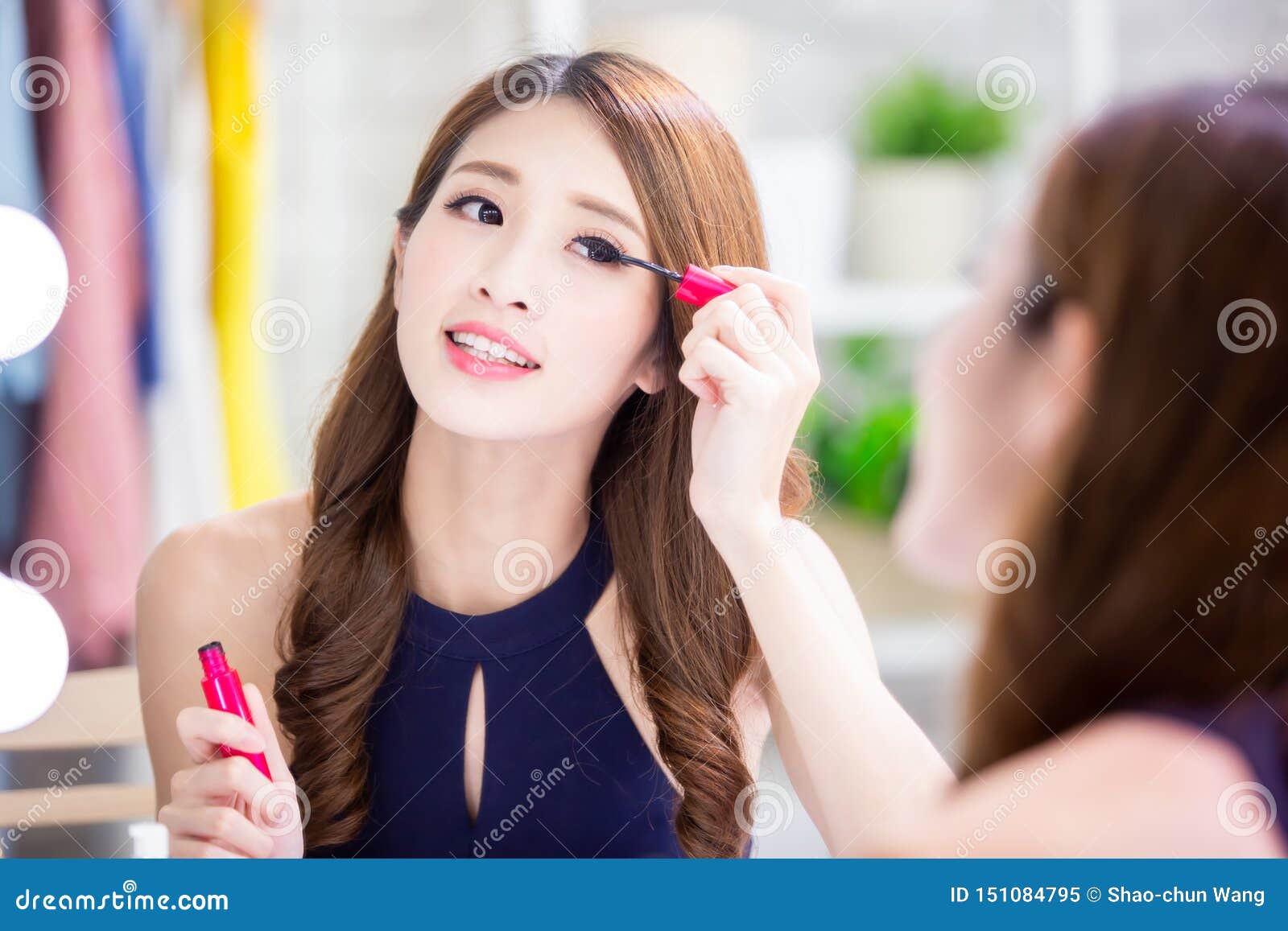 asian woman using mascara