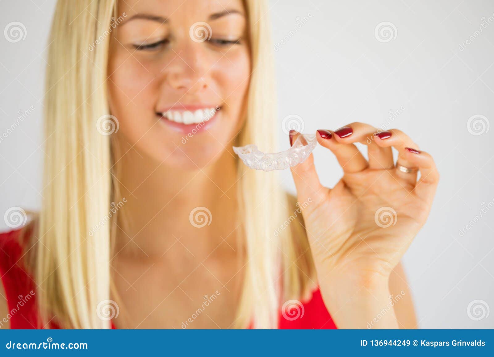 woman using teeth whitening braces