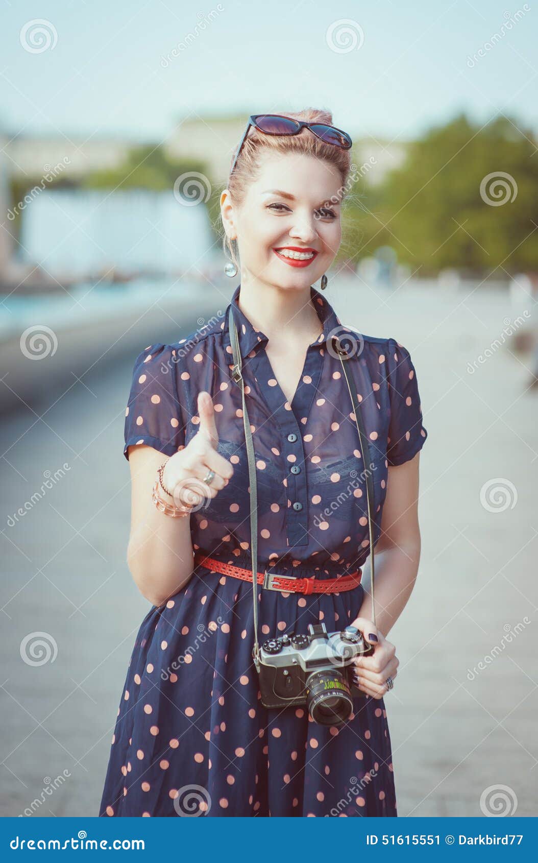 Beautiful Woman in Vintage Clothing with Retro Camera Showing Th Stock Image - Image of