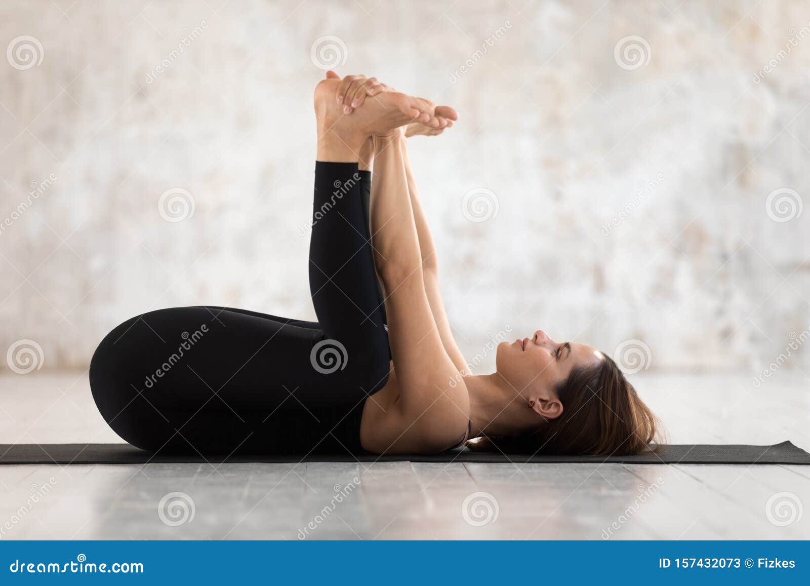 beautiful woman practicing yoga, happy baby pose, ananda balasana