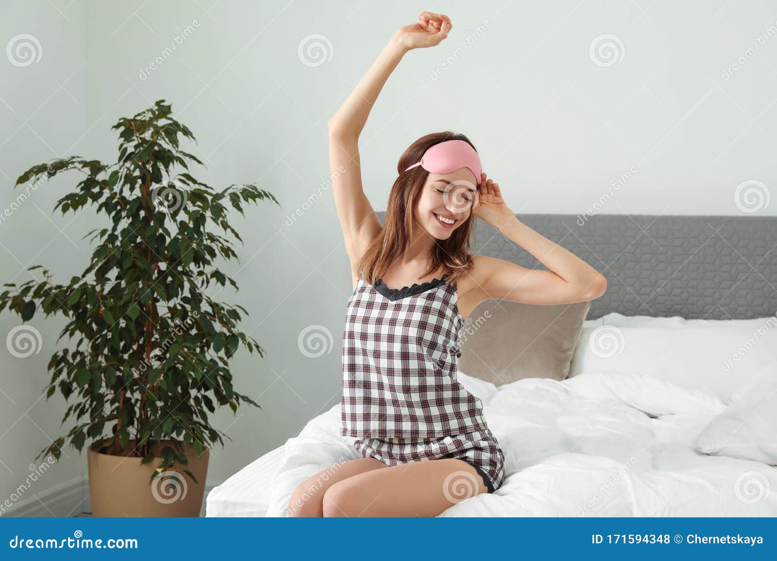 Beautiful Woman Wearing Pajamas And Sleep Mask Bedtime