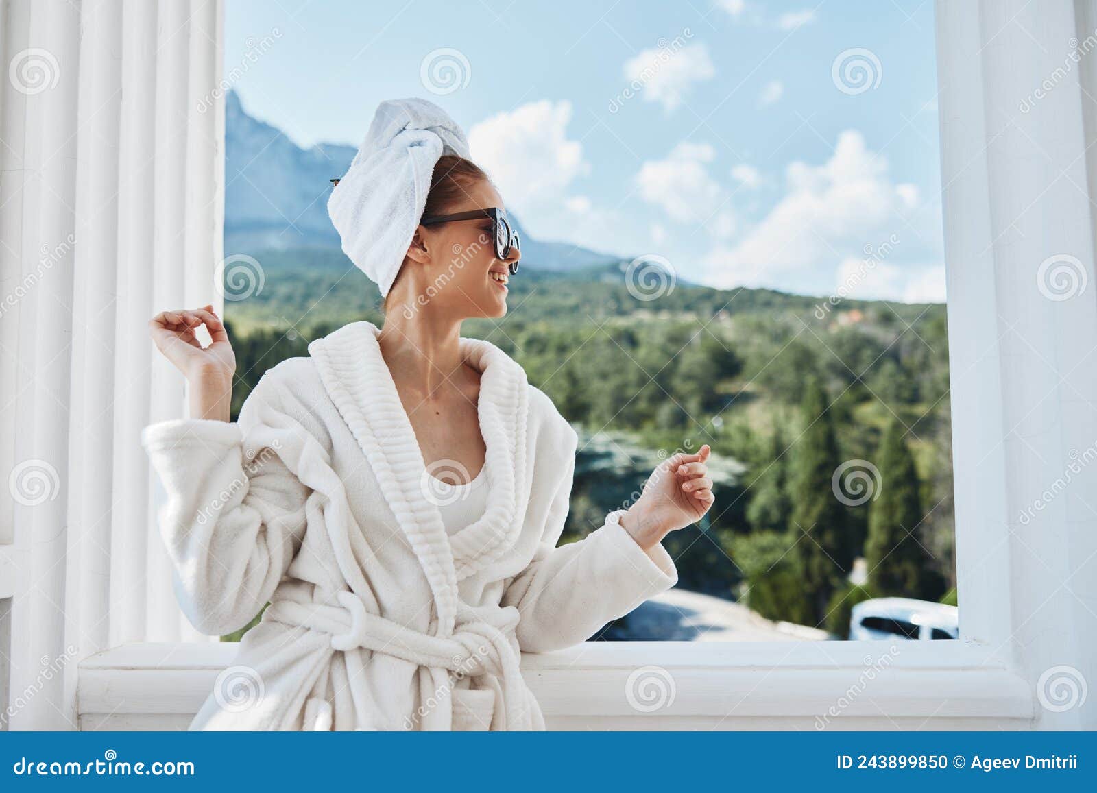 Beautiful Woman Wearing Sunglasses Posing in a Bathrobe on a Balcony ...