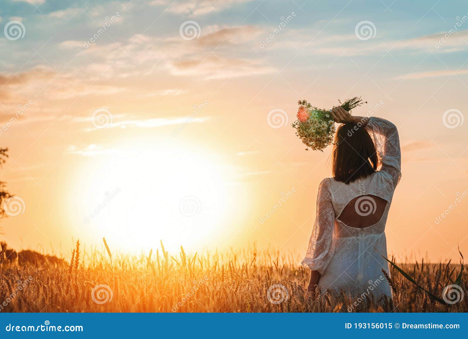 A Beautiful Woman In A White Dress In The Boho Style With A Wreath On Her Head Sitting In A