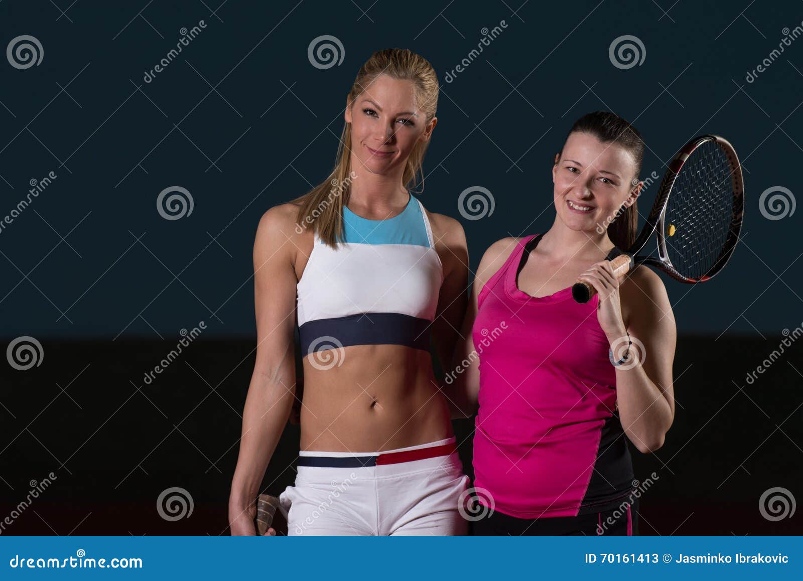 beautiful women playing tennis and looking happy
