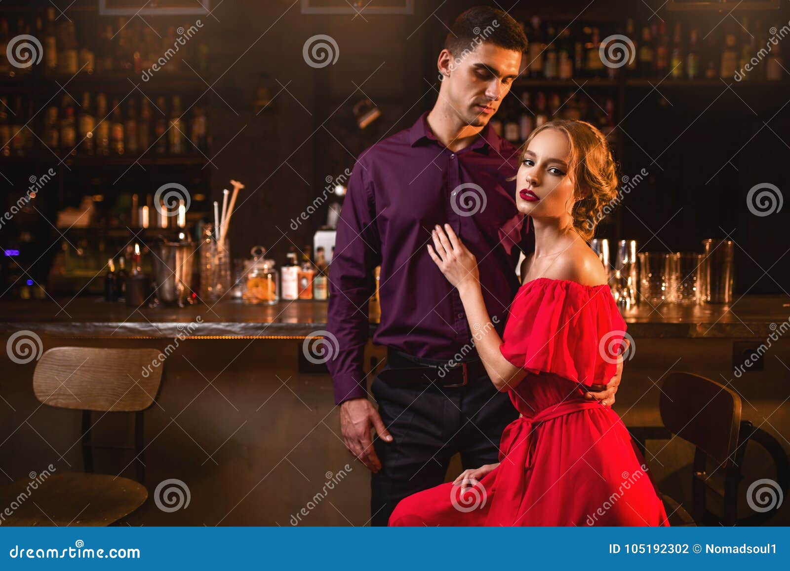 beautiful women red dress her men against bar counter date nightclub attractive love couple pub woman dress 105192302