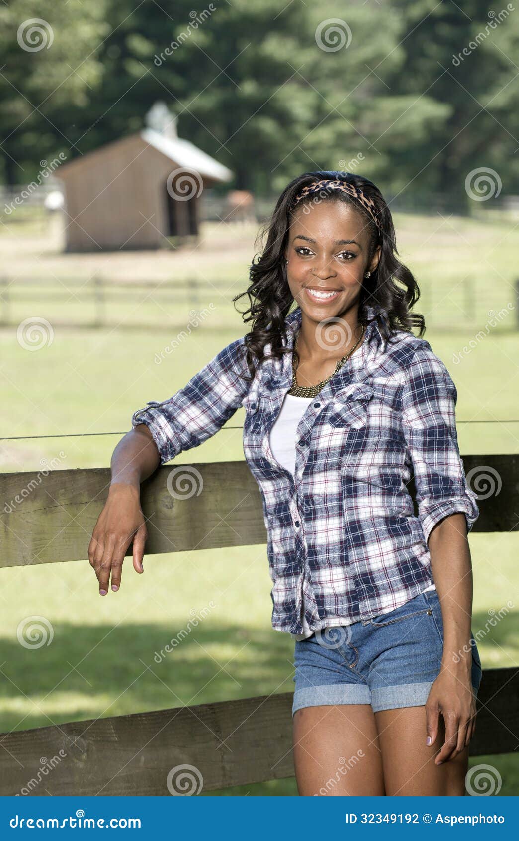Beautiful Young African American Woman Standing Along Farm Fence ...