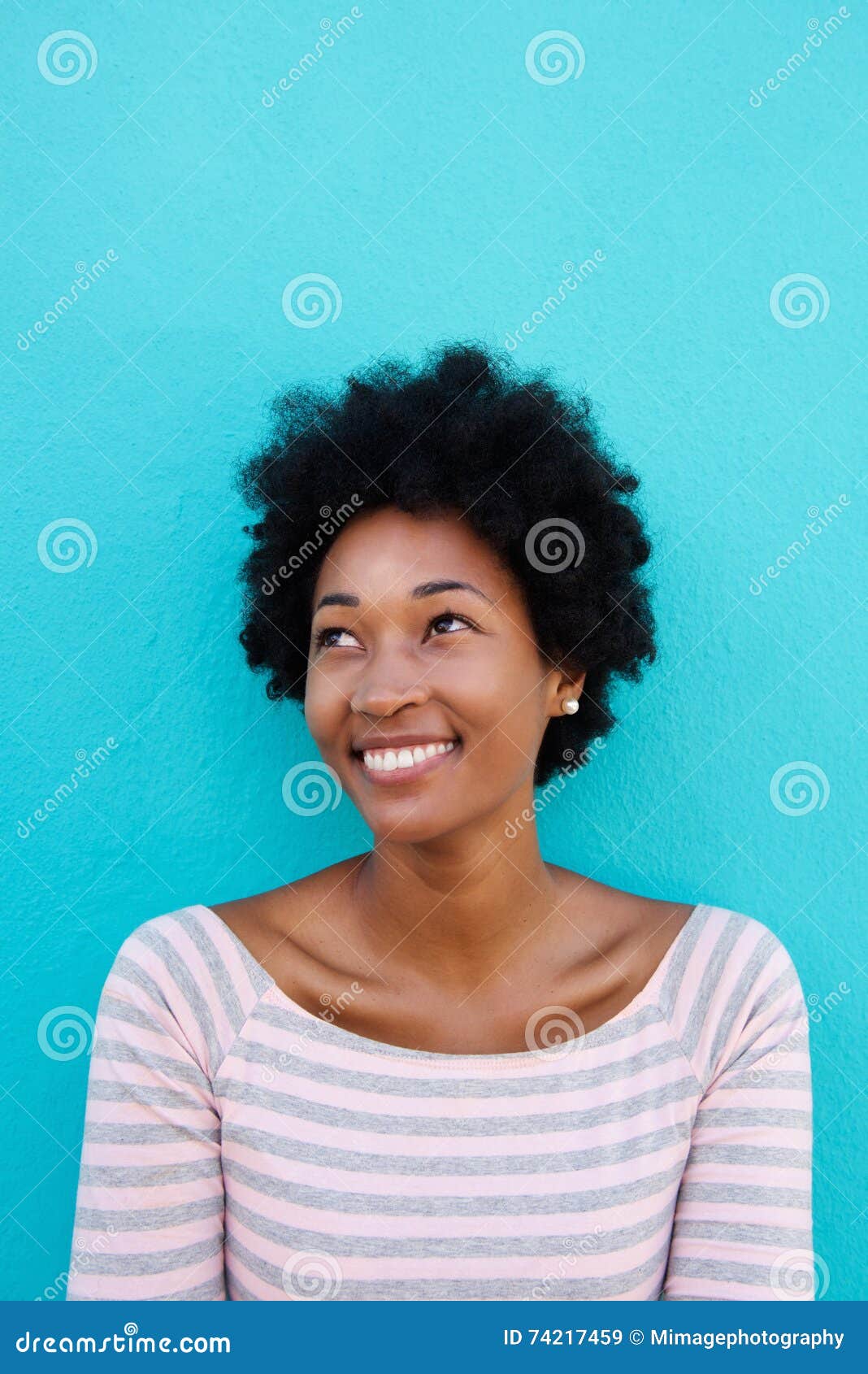 beautiful young african woman smiling with a glance