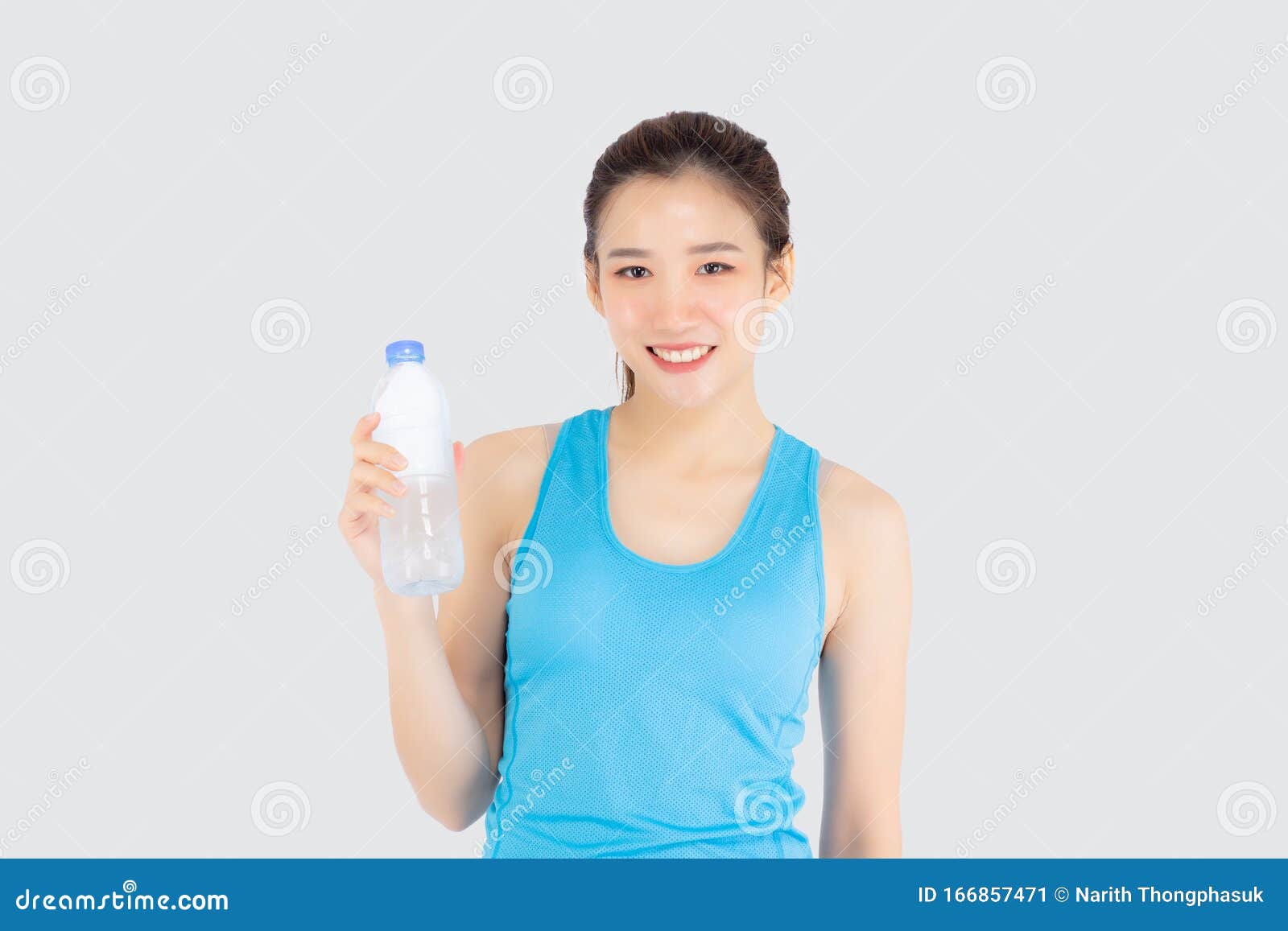 Attractive Sporty Young Woman Drinking from Blue Shaker Bottle in