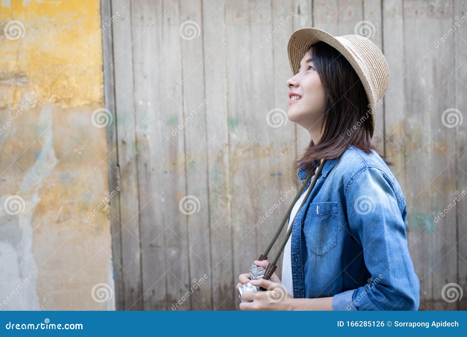 Beautiful Young Asian woman tourist walking in old city area of Bangkok Thailand. Solo travel concept in the holiday.